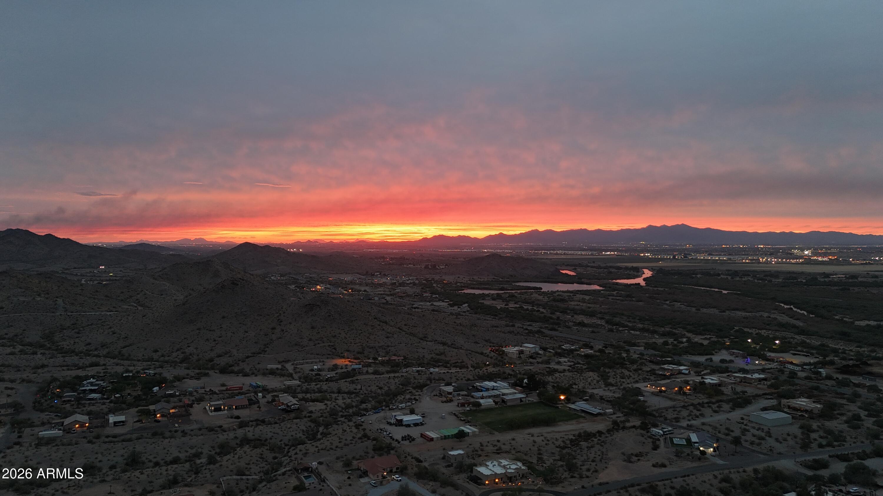 Scenic Territorial-style home on 1.364 acres with breathtaking desert and mountain views! This single-level home features a desirable split-master floor plan, spacious great room with a charming Kiva fireplace, and three secondary bedrooms on the opposite wing. The primary suite offers a walk-in closet, jetted tub, and separate shower. Two separate 2-car garages provide endless possibilities for vehicles, a workshop, man cave, storage, or toys. Enjoy Arizona Sunsets out Back with a large covered patio, pavers, built-in BBQ, fire pit, fenced backyard, lighting and view deck where you can take in spectacular sunsets and forever views. Solar water heater, soft water system, R/O system, shared well, and septic complete this unique property. Fireplace and BBQ are on small propane tanks.