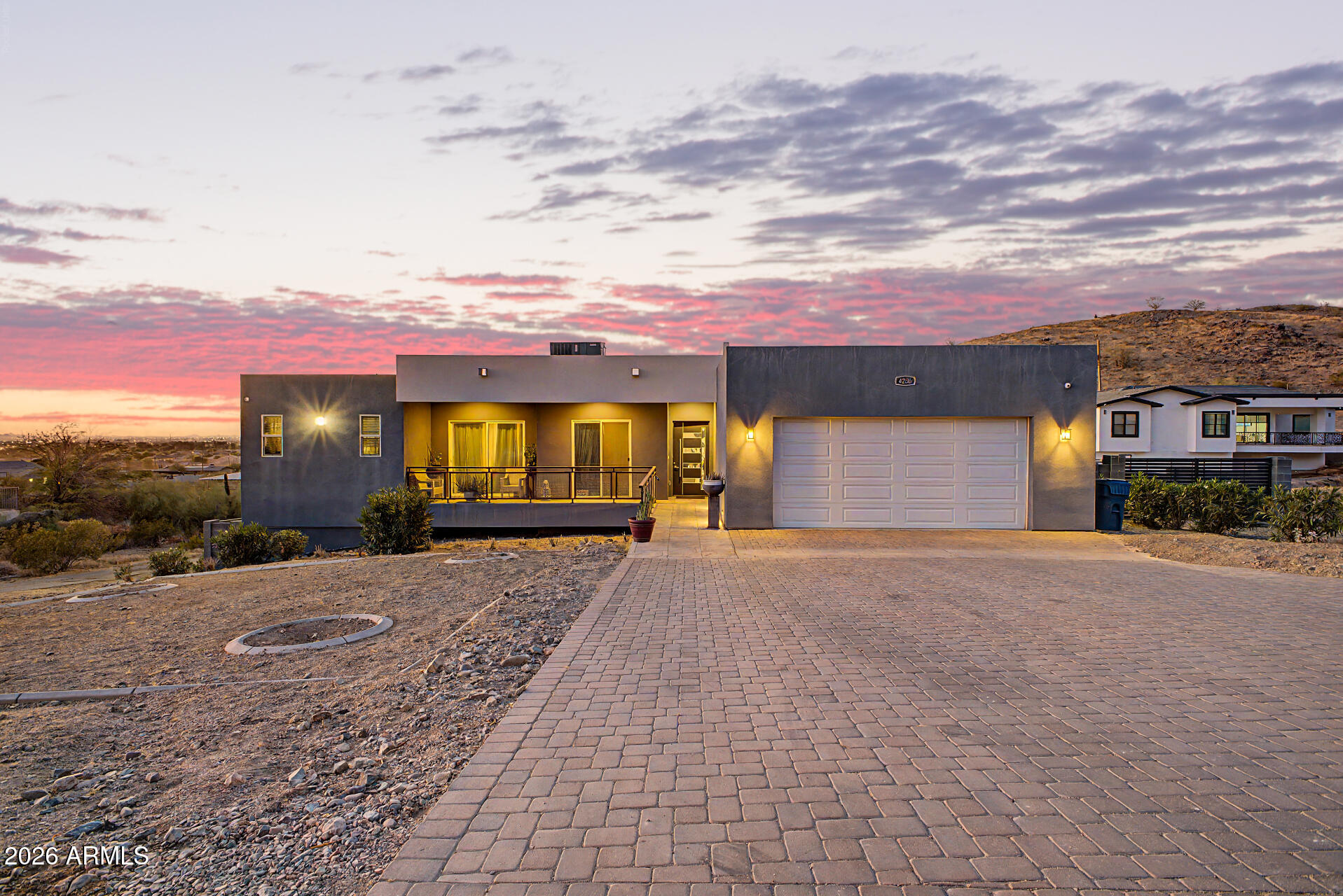 Welcome to this stunning 5-bedroom, 3.5-bath home featuring modern high-end finishes and spectacular views throughout on 1.004 acres of private land. From the moment you arrive, the large paved driveway and impressive curb appeal set the tone for this beautifully updated property.

Inside, the spacious open-concept living area is designed to maximize natural light and showcase the incredible panoramic city views, creating the perfect setting for both everyday living and entertaining. A stylish wet bar complete with a wine fridge makes hosting effortless.

The kitchen takes center stage with gleaming white countertops and cabinetry, accented by a sleek glass tile backsplash and contemporary finishes that blend style and functionality. Welcome to this stunning, ultra-private 5-bedroom, 3.5-bath estate nestled on a full acre of land with absolutely no HOA. From the moment you arrive, the large paved driveway and impressive curb appeal set the tone for this beautifully updated, fully fenced property. For the outdoor enthusiast, the home features dedicated easements connected right to the property, offering seamless access to great local hiking trails.

Inside, the spacious open-concept living area is designed to maximize natural light and showcase breathtaking, panoramic views of the city lights. The home is fully equipped for entertainment with a built-in surround sound system and a stylish wet bar complete with a wine fridge. Throughout the home, modern comfort is key, featuring remote-controlled ceiling fans and the peace of mind of a comprehensive outside security system.

The kitchen takes center stage with gleaming white countertops and cabinetry, accented by a sleek glass tile backsplash, contemporary finishes, and an extra-large pantry for maximum storage.

The luxurious primary suite continues the modern aesthetic with a dramatic statement wall and a truly one-of-a-kind, spa-inspired bathroom boasting custom tile showers. The oversized, custom primary closet is a standout feature, complete with its own dedicated, convenient stacked washer and dryer unit (in addition to the main laundry room).

Outside, the property functions entirely on its own private well and septic system, featuring a specialized potassium water treatment system and an automated sprinkler system to maintain the landscape. This exceptional home perfectly combines high-end elegance, total privacy, and unmatched scenery.