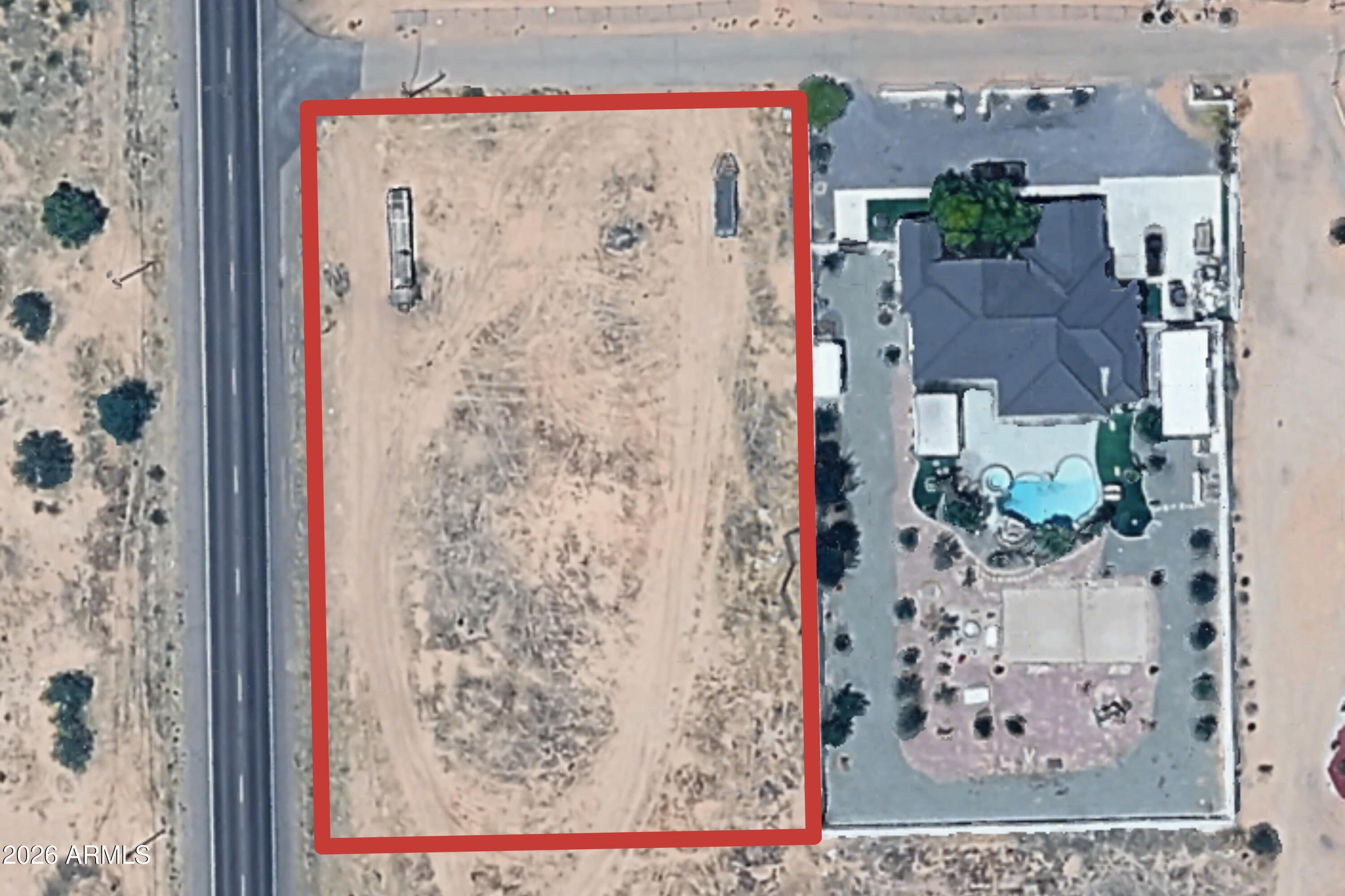 Strategically located vacant land offered in combination with an adjacent improved residential property (Parcel #503-38-037E). Both properties must be purchased together and will close concurrently. Seller owns both surface and mineral rights.

This approximately 1.61-acre parcel offers frontage along Gila Bend Highway (AZ-84), providing strong visibility and accessibility in a rapidly evolving corridor. The offering includes the adjoining 1.25-acre residential estate featuring a fully renovated home and significant capital improvements, creating flexibility for continued residential use, strategic acquisition, or long-term planning.

Positioned within proximity to the Santa Cruz Copper Project, the property presents a unique opportunity in an area experiencing shifting land-use dynamics and infrastructure interest.

Buyers are advised to conduct independent due diligence regarding zoning, land use, access, utilities, and potential future impacts. No representations are made regarding future development or mining activity.