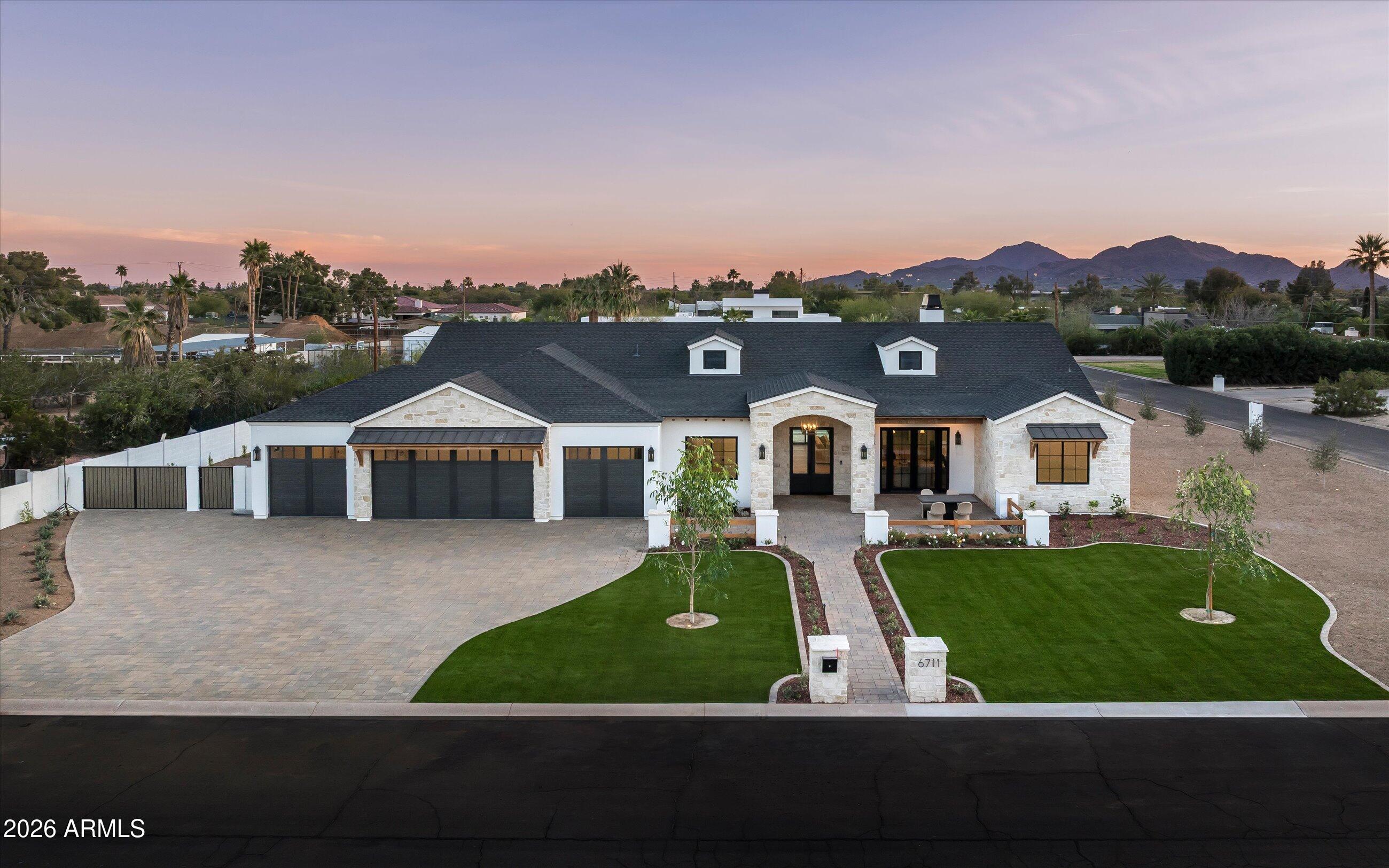New 2026 construction on a 0.83-acre corner lot in 85254, with no HOA and a separate detached guest residence accessed by a private 67th Street entrance. The main residence pairs solid Alder cabinetry, Della Terra Quartz, European Oak, and limestone finishes with a 48-inch dual-fuel range, a Pebble-Tec pool with a Baja shelf and heated spa, and a nine-foot custom fire feature. Construction includes spray foam insulation and a full fire sprinkler system; the home is pre-wired for automation and security. Five garage spaces accommodate primary, recreation, and collection use, and the detached guest residence offers a flexible second living structure with its own entry, suitable for guests, long-form work, or extended stays. Six bedrooms, eight bathrooms, and 5,523 interior square feet are organized around an indoor-outdoor great room that opens to a yard built for year-round use.