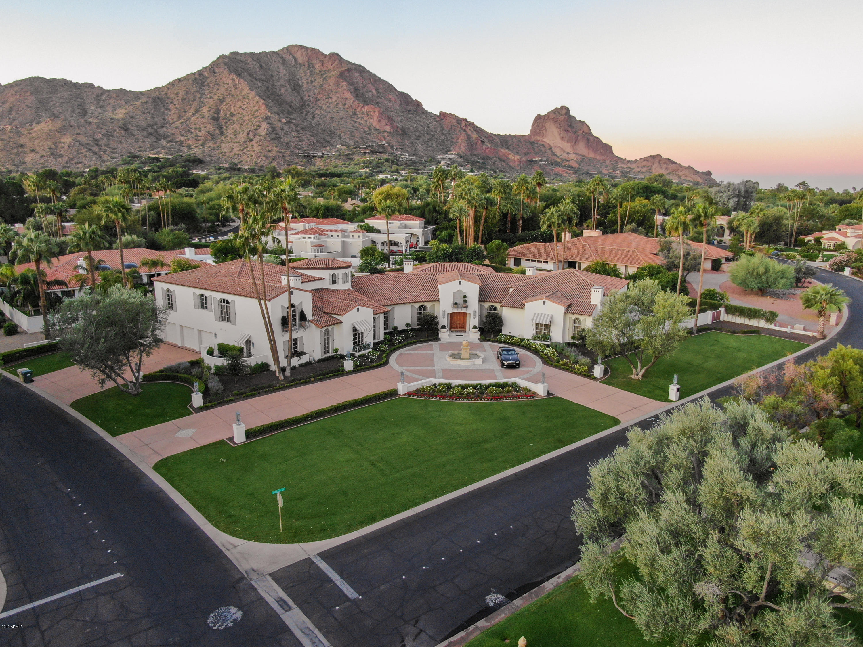 Reduced $1,000,000.Remodeled And Shows Like A 2020 Built Home. 8500 Sq Ft On Main Level With Master Down. Upper Level Guest Wing With Two Bedrooms, Family Room And Kitchen. Guard Gated Finisterre. Located On A Quiet Interior Lot With Views Of Camelback Mountain. Green Grass Lawns And  Circular Driveway, Block And Brick Construction  All Tile Roof. The Finest Finishes. Featuring Warmth and Elegance Throughout. Large Custom  Crown Moldings In Most Rooms. White Marble And Wood Flooring. Wood Paneled Executive Office .Library With Lighted Book Cases. Large Kitchen With Double Subzeros, Wolf Ovens  And La Cornue Gas Stove.. Master Bath With Two Water Closets, Tub With Jets And A Steam Shower.  Rear Yard Has Lush Resort Style Landscaping with Citrus Trees And A Newly Built  Heated Swimming Poo