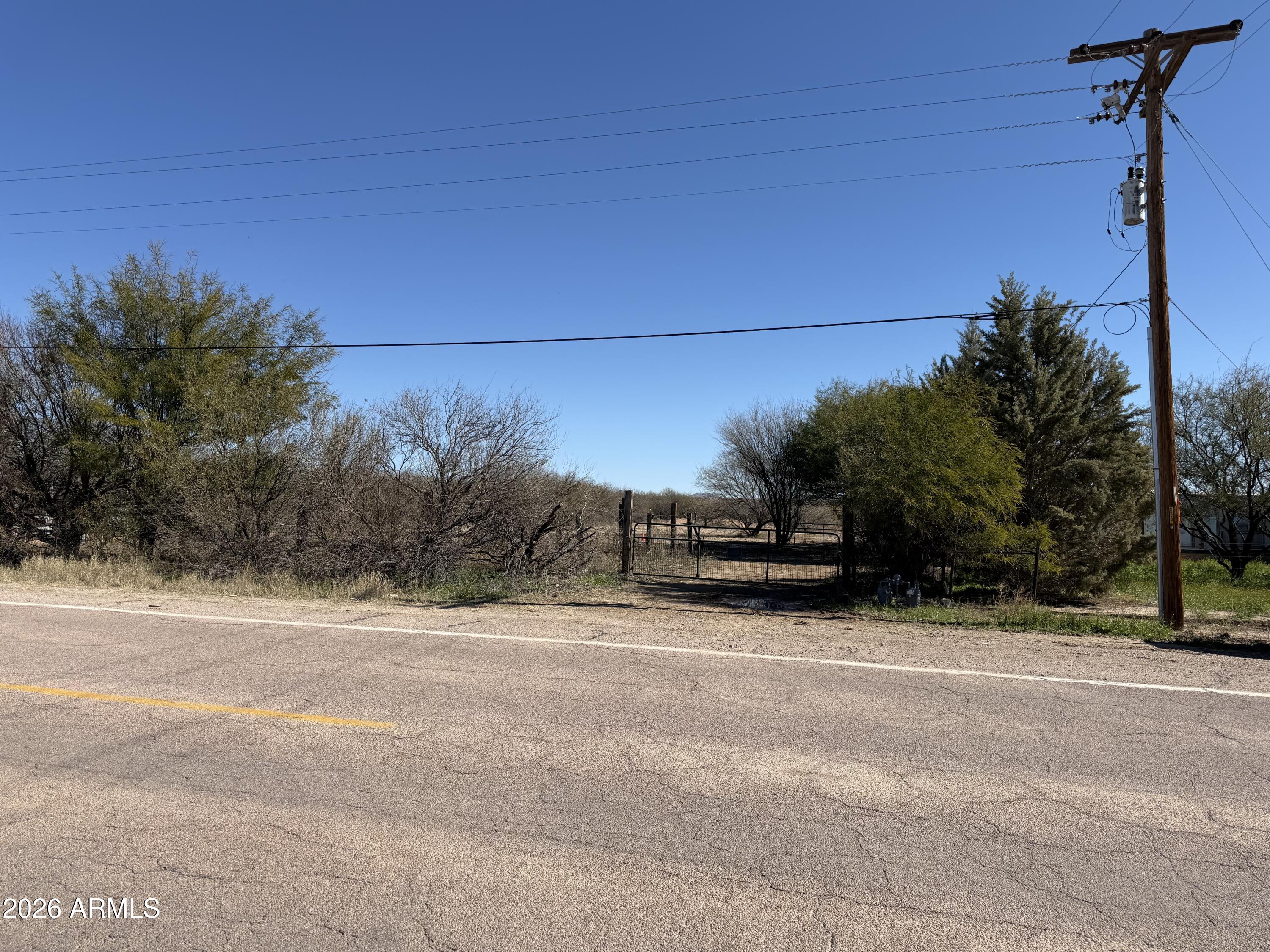 PRICE IMPROVEMENT!!! VACANT LAND located at 1055 N Pomerene Rd in a rural residential area with surrounding homes. This cleared parcel previously had a mobile home on site and includes existing horse corrals, making it a great opportunity for buyers looking to build, place a manufactured home, or invest in the desirable Pomerene area. Utilities are available at the property, including gas, electric, and water. Historical septic documentation has been located; however, buyer to verify condition and suitability for intended use. Buyer to verify all facts including zoning, utility availability, building requirements, and property suitability.