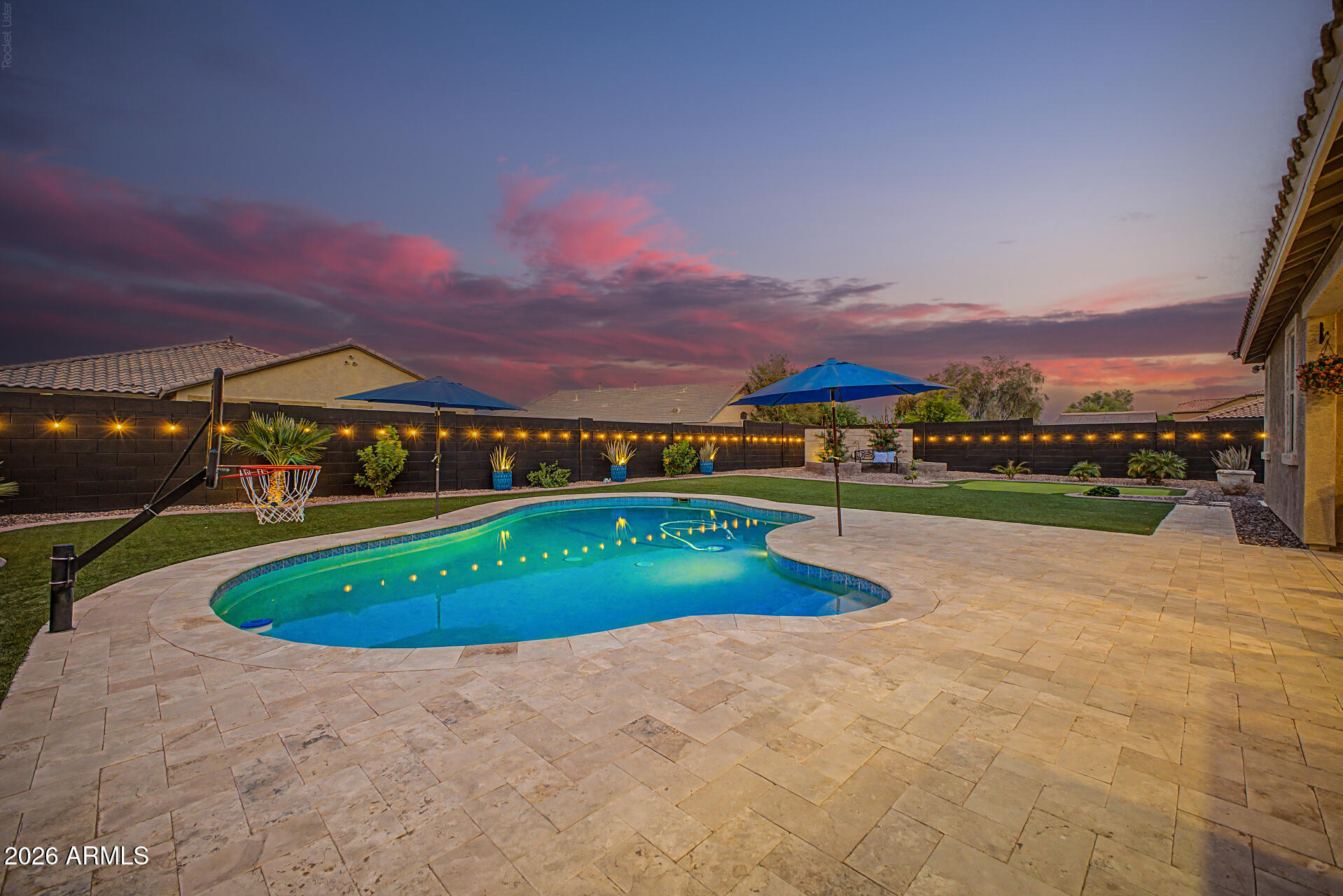 Experience Resort-Style Living in your own backyard OASIS! From the Sparkling Pool, built-in basketball hoop & solar pool cover, to the built-in BBQ grill & putting green! Elegance & Modern Comfort - All in One Gorgeous Home! Located in Homestead North, this gem offers 4 beds, 2 baths, 12 ft. RV gate, 3-car garage & a delightful low-care landscape. The fabulous interior showcases new 4'' plantation shutters, abundant natural light & wood-look tile flooring in all the right places. Enjoy the welcoming living space highlighted by a cozy two-way fireplace that seamlessly connects to the inviting great room! The impressive kitchen boasts a walk-in pantry, recessed lighting, tile backsplash, ample cabinetry w/SS cabinet pulls, a peninsula w/breakfast bar, SS range hood, stainless steel .. appliances with gas cooktop and double wall ovens. 

The main bedroom has sliding doors to the back patio! Its ensuite includes dual vanities, separate tub/shower & a walk-in closet. The split floor plan has two guest bedrooms with plush carpet and a third guest bedroom with laminate flooring. 

You'll love relaxing in your pool, or watching a movie/sports event on your outdoor TV!  Grill up some awesome culinary meals for your friends and family with your built-in BBQ grill.  Then improve your golf game on your own putting green! The well-laid travertine, decorative block wall, and artificial turf are proof that every detail has been thoughtfully designed for year-round outdoor enjoyment. Plus a storage shed for your tools and a 220 volt outlet near the RV gate.  You'll love the epoxy flooring in the garage and stainless steel mounted racks for added storage and there is a new garage motor with Wifi capabilities.
Dream it! Love it! Live it!