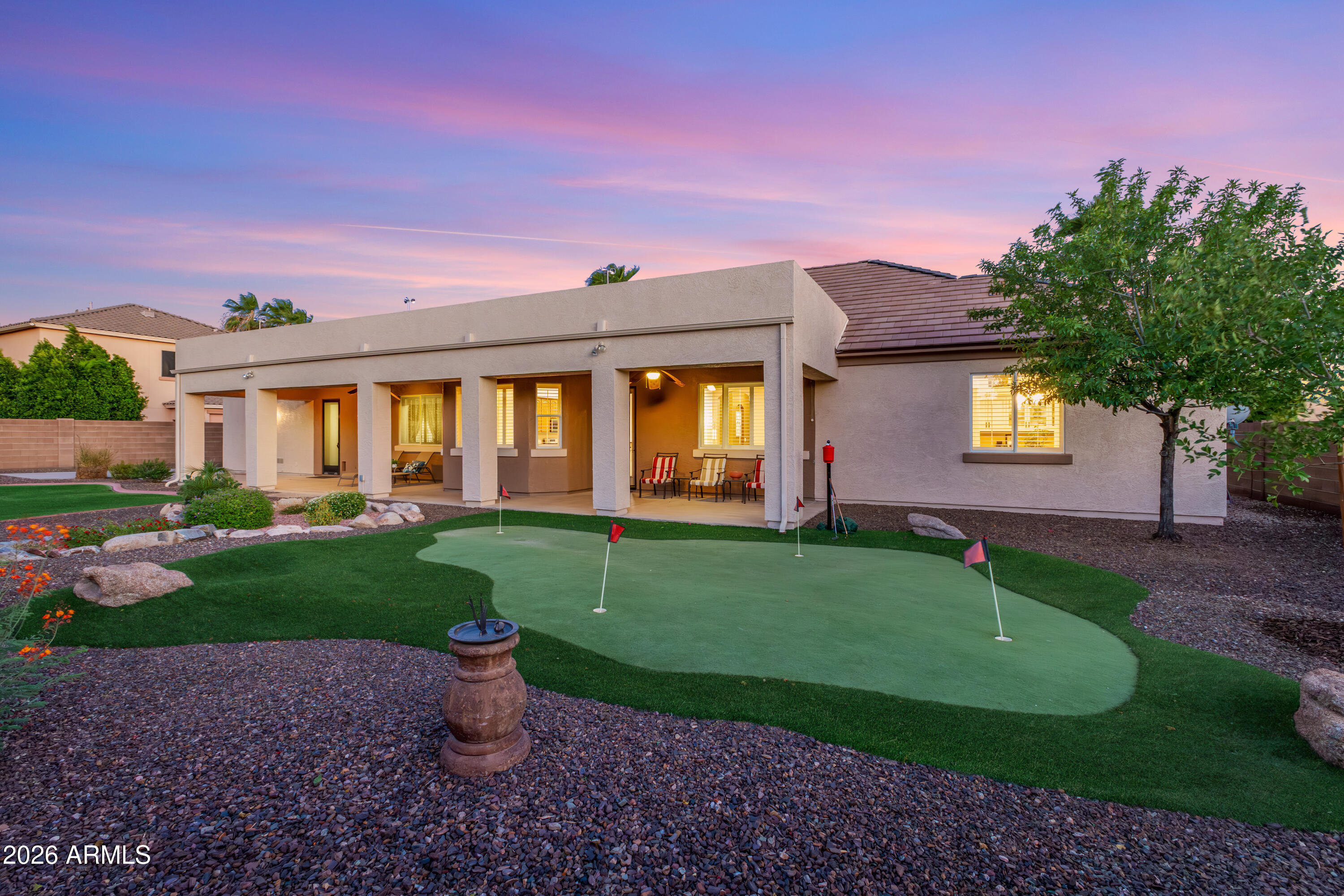 Rare HOA-Permitted RV Parking, a generous 1,100 SF Garage, and an Entertainer's Backyard Oasis on a 15,000+ SF Lot! Welcome to your Northeast Mesa dream home--this immaculate 2,517 SF single-level residence perfectly captures the Arizona lifestyle with an oversized north-facing covered patio, a private putting green, and lush natural grass. Offering ultimate peace of mind with a brand-new 2026 roof underlayment, the property boasts incredible curb appeal outside and mutliple upgrades inside, including plantation shutters throughout, custom built-ins, and a tailored primary suite. A thoughtfully curated interior palette creates a seamless flow, artfully balancing crisp pale cream walls with rich accents of desert modern colors that work effortlessly. It begins with an inviting entry leading into the heart of the home: an expansive great room featuring a tray ceiling and low-maintenance LVP flooring. Nearby, a versatile bonus room serves as the perfect formal dining room, play area, or entertaining space, complete with newer custom cabinetry and distinctive quartz countertops. The chef's kitchen is a true standout, boasting full-overlay maple cabinets, granite countertops, a Bosch counter-depth refrigerator, a 5-burner gas range, a walk-in pantry, reverse osmosis filtration, and an extra-deep sink that opens to a light-filled breakfast nook.

Working from home is a dream in the fully redesigned den, stunningly appointed by Classy Closets with bespoke soft-close cabinetry, drawers, file cabinets, open shelving, soft white quartz countertops, and integrated connectivity access. Retreat to the primary suite sanctuary, featuring a fully customized walk-in closet designed and built by Closet Masters, complete with seeded glass partitions and a built-in fire-resistant safe. The renovated, spa-like primary bath offers dual vanities, quartz countertops, a floor-to-ceiling tiled walk-in shower, and a relaxing Jacuzzi garden tub. Two additional guest bedrooms offer maximum comfort with plush carpeting and expansive closet space, while the well-appointed guest bathroom features a tiled shower surround, granite counters, and extended vanity space. An oversized laundry room provides additional storage with more built-in cabinetry and an extra-deep sink.

Hobbyists will marvel at the rare, oversized 1,100 SF garage, finished with gleaming epoxy floors, built-in cabinets, LED lighting, and a suspended storage rack. The third-car bay is an impressive 27' deep, and an over-height garage door allows plenty of room for high-clearance vehicles. A roomy side yard features double RV gates and a concrete pad, providing extra space for parking and toys--and a newer hot water heater provides added peace of mind. Best of all, RV and boat parking is fully permitted here, a rare find within an HOA!

Alta Mira Estates is located in the highly desirable Northeast Mesa area, just minutes from the Loop 202 with easy access to airports, Scottsdale, Phoenix, and Tempe. This prime location is in close proximity to the Salt River and several lakes, as well as premier hiking, mountain biking, road biking, golf, paddling, kayaking, and fishing--plus, it's a mere one-hour drive to the cool pines of Payson! The community park features basketball and pickleball courts, a children's playground, a covered ramada, and a grassy play space.