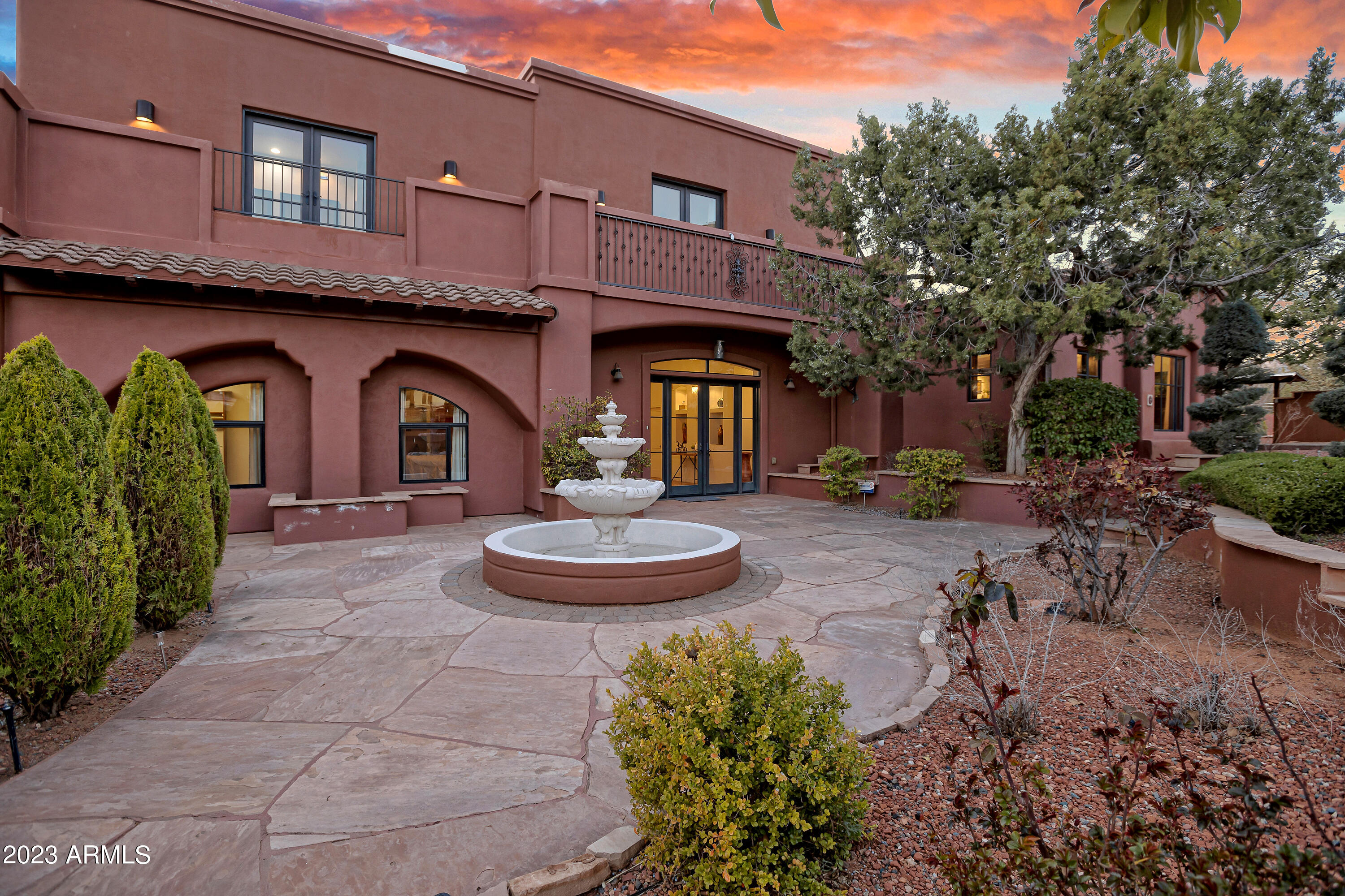 This SPRAWLING WEST SEDONA ESTATE has it all: Main House & Detached Guest House on 2.09 Acres! No HOA, 360 degree JAW-DROPPING VIEWS for miles, Privacy Inside and Out, Fantastic LOCATION, TONS
of PARKING & STORAGE for all your toys, a MASSIVE 4-VEHICLE GARAGE w/workshop area PLUS a HUGE climate controlled pass-through RV GARAGE. Did we mention the pool? This magical and extraordinary retreat is perfect for Large living and entertaining with friends.  Endless interior and exterior spaces to RESTORE and RELAX. The newly remodeled kitchen boasting Cambria Quartz island and countertops. Multiple options for
casual dining directly off kitchen. Your guests can unwind by the fire in the adjacent seating area while you serve culinary favorites prepared on your Chef Grade NXR range with 6 burner gas cooktop.
Total Square Footage: 6,414 sq ft with Main house at 5,250 sq ft and detached guest house at 1,164 sq ft.
Main level offers MASSIVE Primary Bedroom with a captivating stacked rock wall.  Walk out to the expansive rear paver patio and enjoy morning coffee while admiring some of Sedona's most iconic rock formations.
Entertain on the upper level which boasts massive living room/game room, fireplace and two huge viewing decks.  Your guests will gawk at the INCREDIBLE and UNBLOCKABLE views all the way to Mingus Mountain and twinkling lights of Jerome. Cockscomb, Doe Mesa, Bear Mountain and Boynton Canyon to the West and Lizard, Chimney, Thunder Mountain to the East 
Delight your senses in this fully enclosed Meditative Garden of Eden, showcasing Sycamore, Cypress and Mulberry trees.  Fruit trees abound including fig, apricot, peach, pear and decorative plum providing a striking array of color in Spring.  Enjoy a book with your favorite cup of tea under the covered trellis patio, surrounded by lush greenery while you breathe in scents of roses, jasmine, rosemary and lavender.
Stroll over and plunge into the newly designed circular pool with cascading waterfall and soak up the sun with your favorite beverage. Stargaze by the nearby sleek new fire pit/ Practice your short game on the putting green, while your horses frolic a few feet away.
The luxurious detached casita offers a great room with towering 16 ft ceilings, gorgeous dark wood flooring, a SPACIOUS kitchen boasting granite counters, breakfast bar and Samsung Stainless Appliances including 5 burner electric stove, fridge and microwave. Enjoy sunsets and stargazing on the spacious west facing patio.