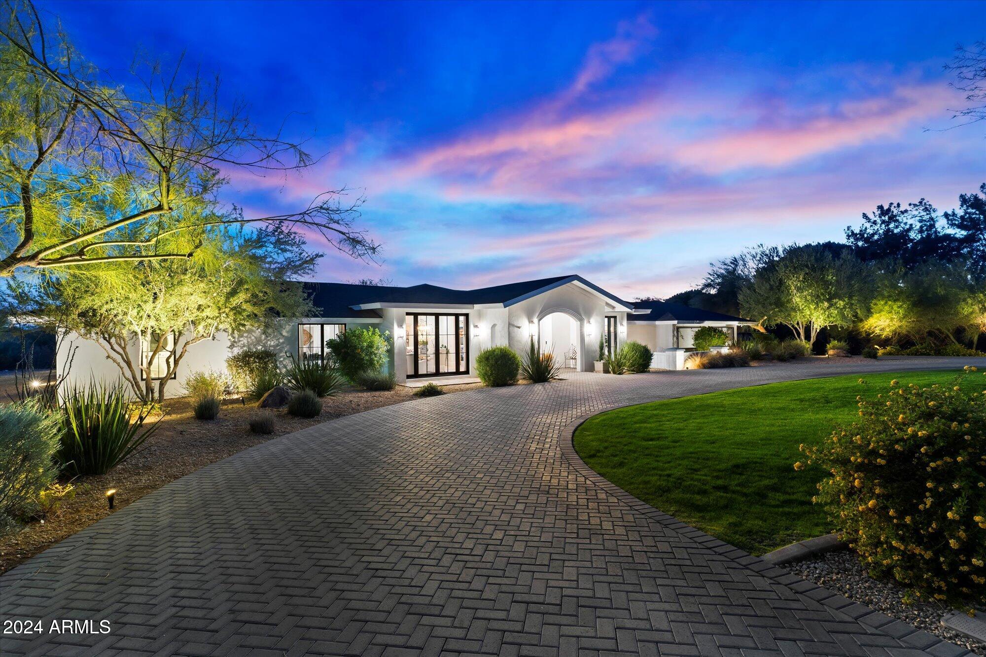 An exceptional value, a Paradise Valley move-in-ready gem, blending style and functionality in a way that's perfect for those who appreciate refined living. The half-circle drive leading up to the home sets the tone for what's to come—an expansive, beautifully updated single-level residence with breathtaking views of both the Phoenix Mountain Preserve and iconic Camelback Mountain. 
The fact that it sits on over an acre of prime real estate, yet is still halfway in between downtown Scottsdale and Phoniex, close to signature resorts, restaurants, shopping, and top-rated schools, makes it even more special.
The home's design feels cozy, with custom windows and French doors that fill the interior with natural light, giving the entire space an airy, open feel. The gourmet custom kitchen is a chef's dream, featuring a gorgeous marble island and herringbone tile backsplash, along with professional-grade Thermador appliances, a wine fridge, and Bosch dishwasher. This kitchen is certainly made for both entertaining and everyday enjoyment.

The Owner's Retreat sounds like a private sanctuary, and with the "showcase closet" and double sliding doors opening to the lush, professionally landscaped backyard, it offers an incredible space for both relaxation and connection with nature. The serene backyard, with its white roses, lavender, espalier trellis, topiary trees, and soft landscape lighting, creates the perfect setting for unwinding by the temperature-controlled pool. This cozy single-level (no steps) home strikes a perfect balance between privacy and convenience. A private tour sounds like a must for anyone to truly value it.