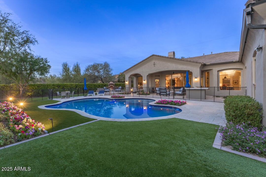 Highly upgraded and modernized 5-bedroom, 5-bathroom single-level residence with guest house situated on an oversized lot within Grayhawk's guard-gated Talon Retreat. This home showcases an open great-room floor plan with elegant wood flooring, designer light fixtures and Lutron lighting system, custom window coverings, and a newly added cabinet wall in the family room with linear fireplace, maple cabinetry and shelving, LED art lights, and decorative ceramic tile.  The family room offers a surround sound A/V system with a 77'' Sony TV, Paradigm speakers, and Marantz Receiver.  The family room A/V system, programable house lighting and blinds, and security systems, can be controlled via remote controls or using mobile apps, and all convey with the home. The gourmet kitchen offers Quartz countertops, a tiled backsplash, large center island with bar seating, stainless steel appliances, built-in wine/beverage refrigerator, new black cabinet hardware, statement pendant lighting, and a refreshed exterior door leading to the backyard.  

A private detached casita off the front courtyard offers a true guest retreat, complete with new carpet, updated lighting, window shades, and a remodeled bathroom. Additional secondary bathrooms have also been fully remodeled with updated finishes throughout. 

The backyard is a show-stopper, extensively enhanced with a fully remodeled pool with new Sea Glass pebble interior, blue waterline tile and LED lighting, all-new Pentair pool equipment, and an above ground Sundance spa, new landscape lighting and irrigation, a new pool fence, newly installed BBQ, new slab countertop at the BBQ island, a gas fireplace with seating, expansive travertine decking, and in-ceiling surround sound at the covered patio.  This is truly a backyard for year-round enjoyment. 

Notable additional upgrades include a new 2-ton 18 SEER Trane HVAC system for the guest bedroom wing, a new mini-split for the casita, full interior and exterior repaint, programmable roller black out shades, new garage door openers with cameras, upgraded network wiring and Ethernet ports, a Kinetico water softener, multiple new Sony TVs, and enhanced lighting throughoutincluding new foyer and dining chandeliers.

This meticulously updated Grayhawk home offers turnkey luxury, modern systems, and exceptional indoor-outdoor living in one of North Scottsdale's most sought-after gated communities.