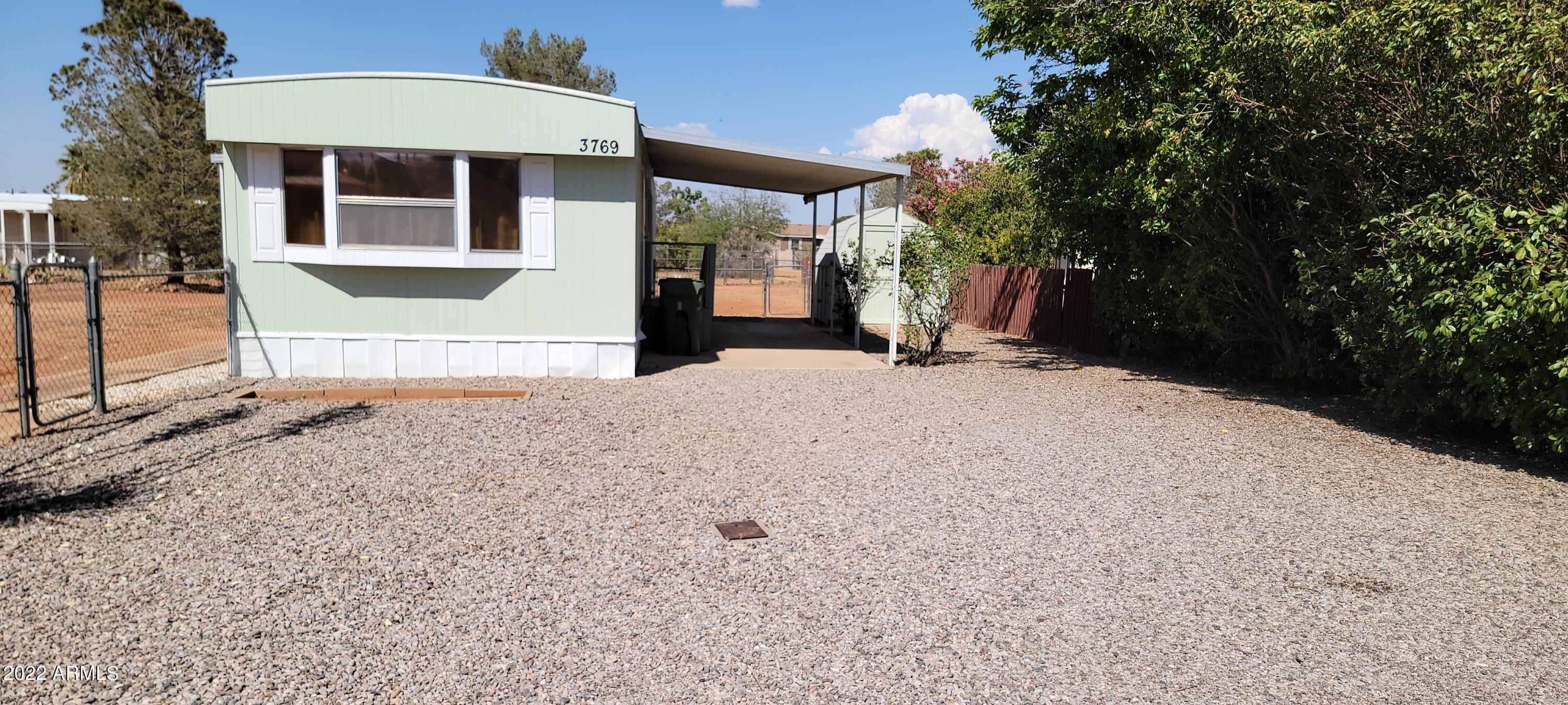 You will love this very cute home! It has had many updates and upgrades and it is just waiting for new owners.  There are 2 bedrooms at opposite ends. The master bedroom has dual sinks and a door to a back patio. It also has 2 closets and is nicely sized. There is newer laminate flooring and the appliances in the kitchen are also almost new. There is a cute eating area in the kitchen and a nice sized living room. This home has been freshly painted inside and out. The roof was recently recoated. You will love the screened patio with new decking all year around. This lot is much larger than most and it is very well landscaped. You will not want to miss this special home.