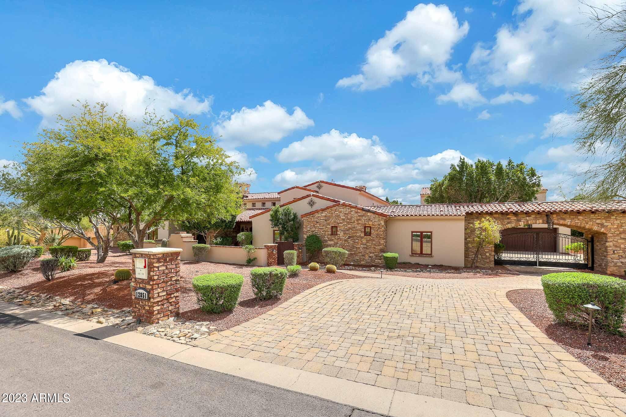 Welcome to this privately gated custom estate of your dreams with no HOA built by DeAcetis-Francis, situated on almost an acre at the base of the McDowell Mountains! Enter through the courtyard and into the grand foyer. Absolutely no expense was spared in the design of this impeccable estate with 6 bedrooms - all Ensuite! Gourmet chefs kitchen with Subzero and Wolf appliances, two sinks, plus a full bar with beer tap and wine cellar off the living room! Walk out basement with game room and kitchenette, and home theatre. Recently built and privately accessed guest house with elevator in garage with separate kitchen, bedroom, and bathroom. Resort style backyard with diving pool, spa, gazebo, fireplace, misters, outdoor pizza oven, Viking BBQ, fridge, sink, surround sound, playground and more Take the spiral staircase up to see the valley's best city and mountain views from the expansive rooftop deck!  Recently painted inside and out, newer water heaters, pool equipment and wine cooling system! Truly too many great features to list, you have to see it to take it all in!