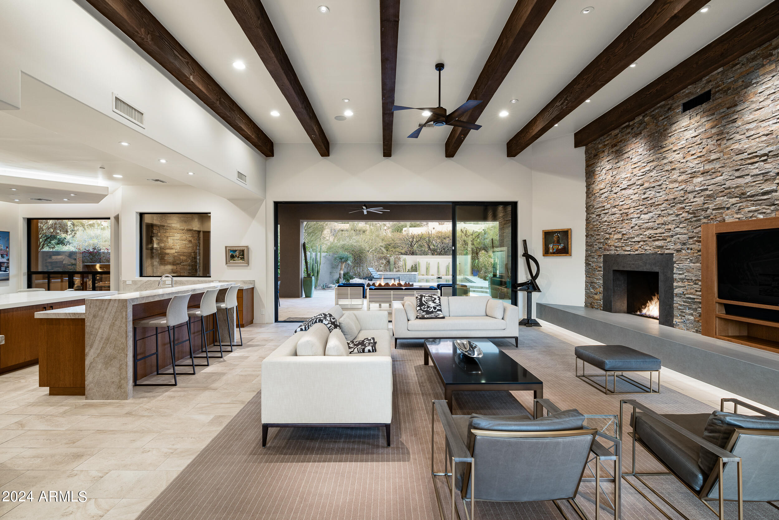 GOLF MEMBERSHIP TO THE ESTANCIA CLUB AVAILABLE SUBJECT TO BOARD APPROVAL.  Recently renovated single level, contemporary design in the guard-gated community of Estancia. Open, great room floor plan with a double island kitchen that flows seamlessly into the great room and through a wall of glass to the outdoor living spaces. Interior details include Italian  porcelain tile and oak plank flooring, custom cabinetry and doors, quartzite counter surfaces, new custom plumbing and lighting fixtures and a chefs kitchen with Wolf and Subzero stainless steel appliances. Outdoor living includes a large covered patio with BBQ station, a fireplace, a firepit, 4 built-in infrared heaters, and a newly constructed and heated pool and spa. A three car garage completes the residence.