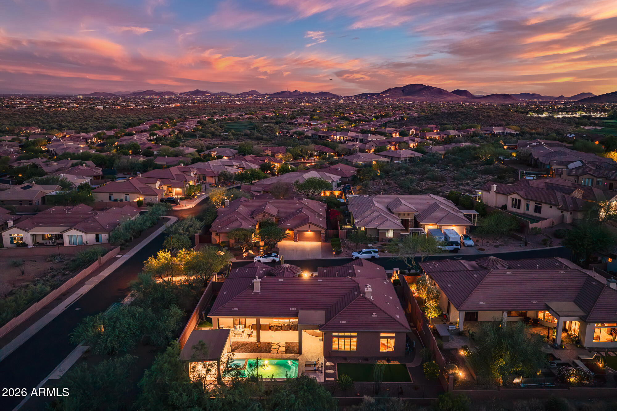 Experience luxury country club living in this exquisite Brentwood model filled with upscale amenities and designer upgrades throughout. Split floor plan with a serene primary retreat featuring a gas fireplace, spa-inspired bath with double-head shower, illuminated mirrors, garden tub, and dual walk-in closets. Gourmet kitchen boasts custom cabinetry, oversized island, pot filler, RO system, Wolf 6-burner double oven gas range, and Sub-Zero refrigerator. Travertine flooring, plantation shutters, custom paint, designer lighting, wood office floors, and elegant media wall with electric fireplace. Resort-style backyard offers pool/spa with Baja shelf, ramada with gas fireplace, putting green, turf, dog run, and breathtaking mountain and wash views. New windows throughout!