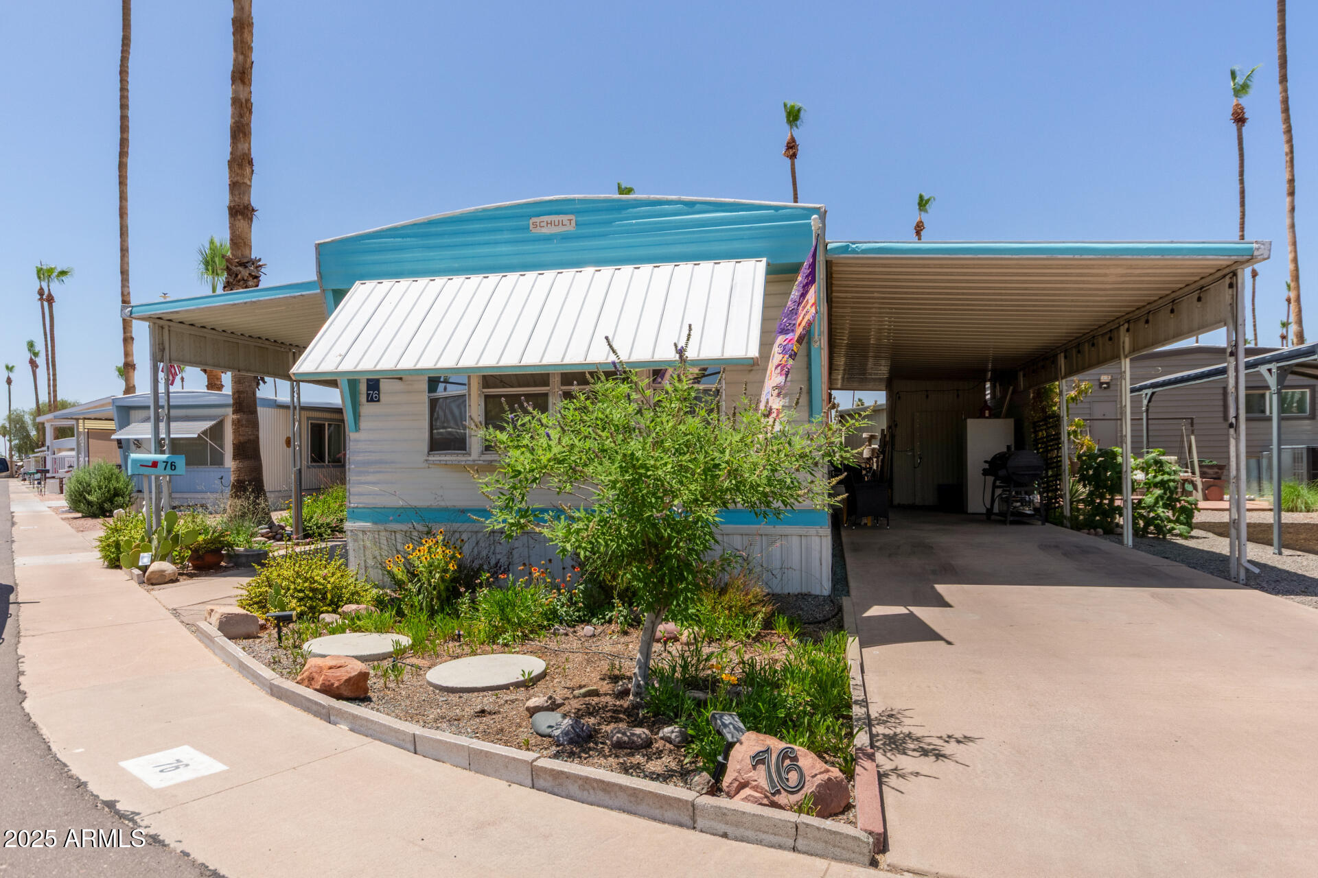 Check out this lovely 2-bedroom mobile home in the sought-after Citrus Gardens 55+ Community! Offering a  covered patio convenient carport parking! Inside, you'll find Lifeproof Rigid Core Vinyl Plank flooring, natural light, recessed lighting, central Air Conditioning, and neutral paint. The kitchen features slab cabinetry for ample storage, a tile backsplash, plenty of counter space, and built-in appliances. Enjoy endless hot water with the tankless water system and dual filtration system as well! You'll love the 2 spacious bedrooms and 1 bathroom. The patio showcases a vibrant desert landscape that adds charm to this home. You'll have access to the community's perks, such as the pool, spa, pickleball, workout center, and more! You don't want to miss it!