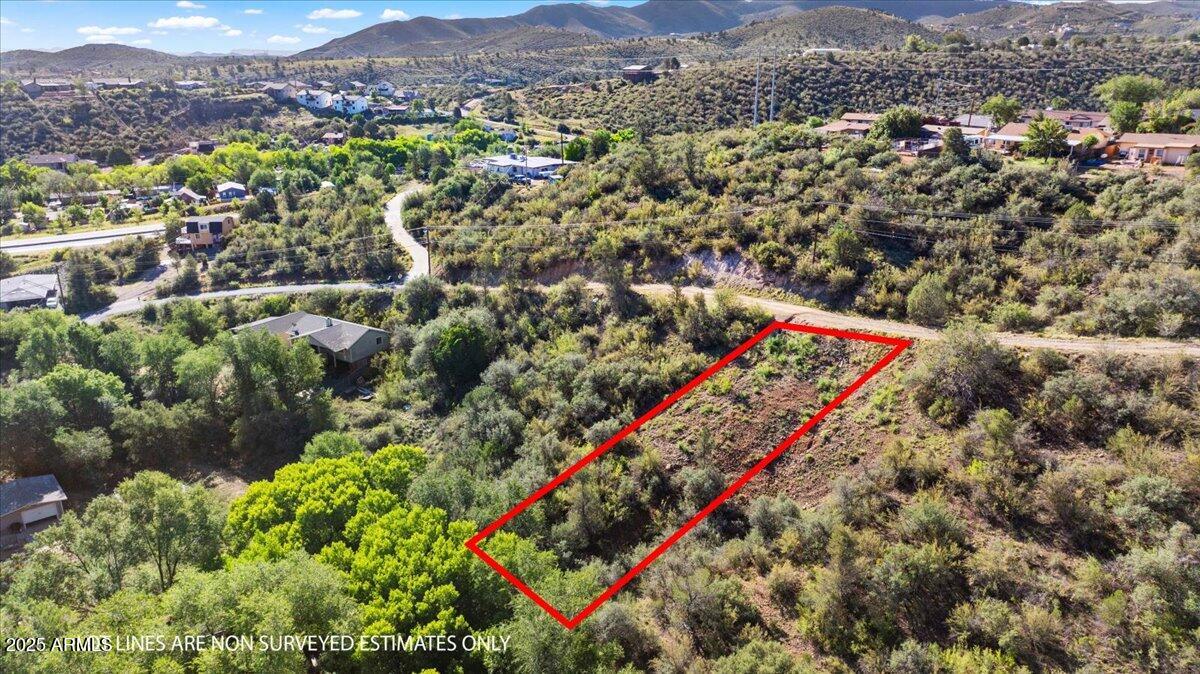 Welcome to 1610 N Emerald Drive, a hidden gem tucked into the hills of Diamond Valley in beautiful Prescott, Arizona. This 0.26 acre residential lot offers stunning mountain and juniper pinon views, ideal for those dreaming of a peaceful retreat with nature right outside your door. The sloped terrain is perfect for designing a custom site-built home that captures elevated views from every angle, making the most of the tranquil landscape.

Located on a paved and county maintained road, the property ensures easy access all year long while still offering the privacy and serenity of a tucked away neighborhood. Cable TV, telephone, propane, and private water are available, and water service is already connected. Septic installation will be required and buyers are encouraged to connect with APS to verify electric availability.

This lot is part of Diamond Valley Unit 2 and is conveniently situated just minutes from Highway 69, placing you close to shopping, dining, and medical services without compromising the natural setting. There's no HOA, giving you more freedom to design and build your dream home the way you envision it.

Whether you are planning your primary residence or a weekend getaway, this lot delivers the perfect foundation to build something special. Wake up to mountain views and enjoy evenings under star-filled skies in a quiet yet accessible location. Come walk the lot and imagine the possibilities for your next home in Prescott.