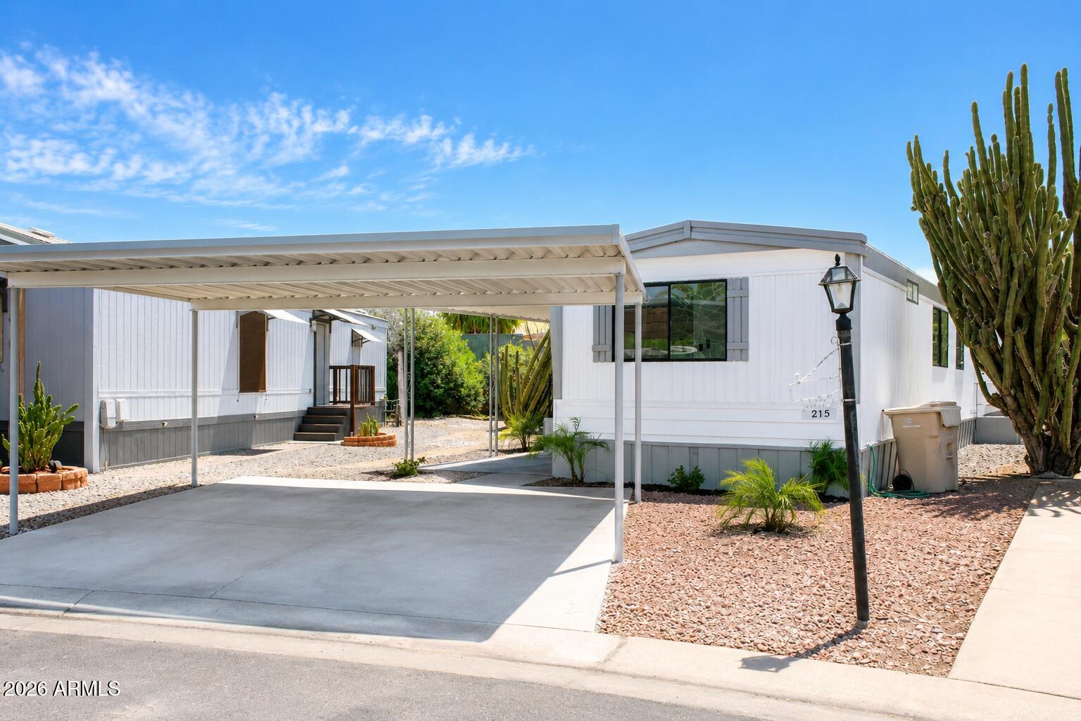 Welcome to this beautifully remodeled manufactured home offering modern updates, stylish finishes, and exceptional value! This move in ready home features fresh interior and exterior paint, new flooring throughout, updated electrical, new light fixtures and ceiling fans, and brand new baseboards and trim that give the home a clean, contemporary feel.The updated kitchen offers new upper cabinets, included appliances, and ample space for everyday living. The spacious primary suite features a beautifully updated bathroom complete with a walk in shower, a full size soaking tub, and plenty of room to relax.
Step outside to enjoy the large patio deck with new flooring, perfect for entertaining or enjoying Arizona evenings. A storage shed is also included!