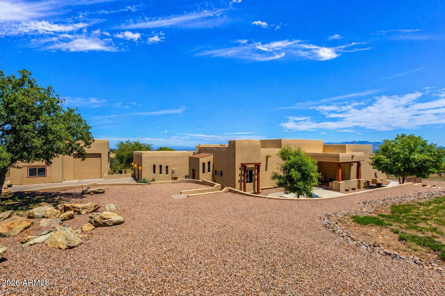 Tucked gracefully along the hillside of the Huachuca Mountains, this spectacular canyon estate offers a rare blend of privacy, luxury, and natural beauty across five acres dappled with majestic oak trees. 


Designed to embrace its breathtaking surroundings, the property captures sweeping panoramic views and an effortless indoor-outdoor lifestyle.

The main residence spans over 3,300 square feet, thoughtfully crafted for both refined living and exceptional entertaining.

At the heart of the home, the gourmet kitchen is a true showpiece, featuring custom cabinetry, a striking butcher-block island, granite countertops, and impressive 60-inch built-in stainless refrigerator and freezer.

The living and formal dining room capture the essence of Southern Arizona living. A beautifully appointed den offers an ideal space for a home office, a secondary living space or would make a great bedroom.

The primary suite is a private sanctuary, complete with its own deck and direct access to a wrap-around patio--perfect for morning coffee or quiet evenings under the Arizona sky.

The main residence also has a second full master bedroom with a private bath and walk-in closet.


Throughout the home you will discover beautiful, stacked stone accents, new tile flooring, knotty Alder doors and trim, adding warmth, with a touch of sophistication.

Step outside to discover a nature lover's paradise, where a gorgeous, covered patio, custom pathways, and peaceful surroundings create a feel of paradise.

The property also features a private well and a 900 sq. ft. apartment, a perfect retreat for visitors or extended stays. 


Car enthusiasts and hobbyists will appreciate the expansive RV garage with generous ceiling height--perfect for a lift, workshop, or ultimate storage solution--along with an oversized two-car garage for everyday convenience.


This is a one-of-a-kind canyon property and ideally located near Coronado National Monument, Our Lady of the Sierras, the Sky Island Summits, Bisbee and Sierra Vista.
This property offers a rare opportunity to experience Southern Arizona living at its finest.