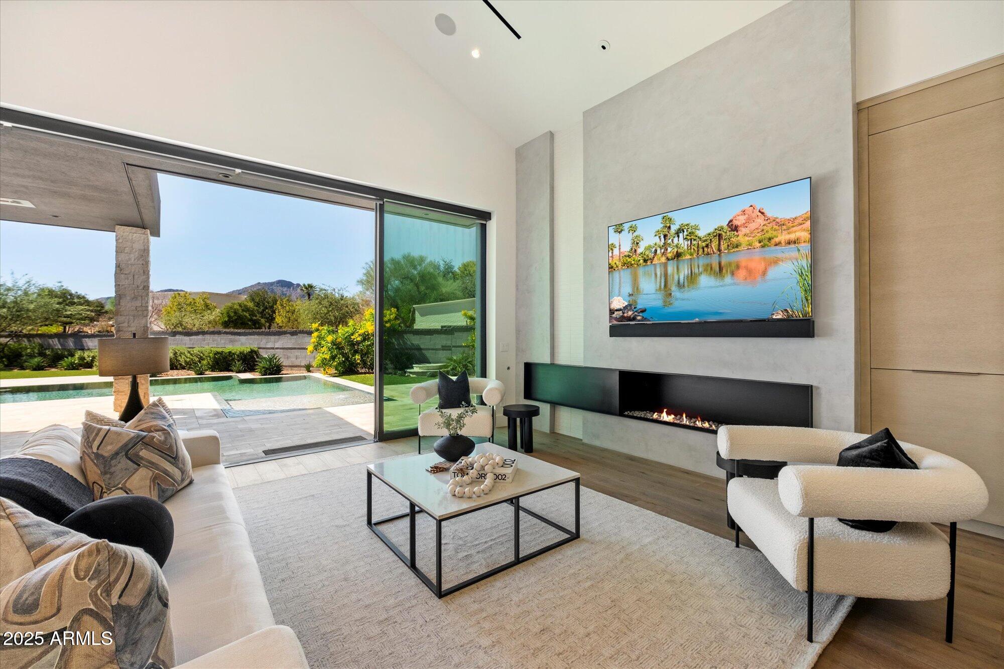 In the heart of Paradise Valley's prestigious Azure community, this rare single-level estate has three dwellings. Set on a coveted large pie-shaped lot, the main residence offers 3 bedrooms and 3.5 baths, a detached guest house, and an additional detached 2 car garage.  High-end finishes throughout with  Gaggenau appliiances, French oak floors Walls of glass open to a peaceful resort-style backyard with a negative-edge pool, Baja shelf, spa, firepit, and views of Camelback Mountain. Enjoy an unmatched lifestyle behind a guard gate with walkable access to fine dining, boutiques, the Ritz-Carlton path, and the future Palmaire Mall. Sq ft includes a 564 sf ghouse.  Practically new, barely lived in.