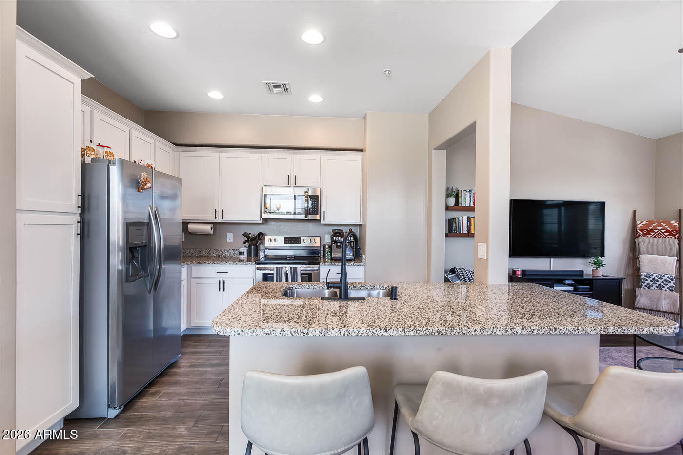 JUST A SHORT WALK TO DOWNTOWN GILBERT and the NEW Heritage Park expansion! Located in the gated community of Via Sorento, this beautifully maintained two-level townhome offers the perfect blend of comfort, convenience, and style. The owner has thoughtfully updated and meticulously cared for the home throughout ownership. Inside, you'll find wood-look tile flooring, fresh paint, vaulted ceilings, fire sprinklers, and abundant natural light. The kitchen features granite counters, stainless steel appliances, white cabinetry with crown molding, recessed lighting, and a large island with breakfast bar seating. The spacious primary suite includes dual sinks, a walk-in closet, and plush carpet. Enjoy peaceful mornings or evenings on the private balcony overlooking the neighborhood.