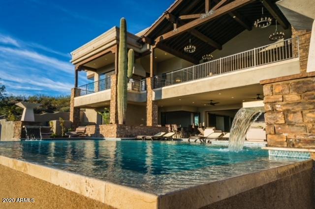 This Exclusive Residence sits atop the Crestview Summit with expansive 360 degree views of the mountains, city lights and sunsets.  Disappearing glass doors lead you out to the breathtaking viewing decks. Chefs kitchen boasts Monogram appliances,  custom cabinetry, sub zero fridge, double island to entertain. Sink all your cares away in the master retreat with sunk in tub, 2 fireplaces, cedar sauna, double entrance shower, private balcony! 5 en-suite bedrooms, 2 Executive offices, 9 baths, 5 car garage. One main floor. Enjoy the 140'' IMAX theater room, Pinball in the game room or wine from the 300 bottle cellar. Your outdoor oasis awaits you with a negative edge, 3 sided pool, oversized spa, fog/mist/light and music system! Entire home is completely automated with Control4System from your Smart phone! Must read all to appreciate the details and amenities below!!!
2200 sq ft approx of covered exterior livable space
2000 sq ft approx of uncovered upper and lower patio living spaces (observation and pool deck areas)
Upper 2 car large garage with coated epoxy floors (700sq ft)
Lower 3 car large garage with coated epoxy floors and extensive storage cabinets and workbenches throughout- also has workout area with television connected to home automation Control4 system (approx 1200 sq ft)
30' native saguaro cactus is highlight of home sitting right inside of the home build area
Other large native cactus surround the area
Travertine Noche high grade flooring throughout laid out in Versailles pattern
Solid Hardwood Oak flooring throughout home
1 upper office or luxury guest suite with full bath, bar area and privacy
1 main floor office
2 powder rooms
Large lower games room with area for pool table, shuffleboard, pinballs machines and other games with large triple pocket in wall slider to pool
Large two tiered media room with 4K projector onto 140" IMAX sound screen with speakers and sound behind. Reclining theater seats as well as bar top area with stools, and swivel love seats below. Seats 10+ guests
Indoor/Outdoor full custom bar area on lower deck opens for entertaining with accordion glass windows and pocket patio door. Scotsman high output ice machine, lower dishwasher and drawer microwave appliance. Barstool area out to pool
Custom open theme wine cellar (300+ bottle capacity) with travertine accents and LED multicolor accent lighting connected to home automation Control4 system
Multiperson steam room area with access to lower pool. Features dual shower heads, full travertine stone with seating area for 3+ guests, (10KW Mr Steam high output steam system with touch control and remote start capability)
High end quality plumbing and electrical fixtures on every area of the home.
Waterfall art feature that runs 24' from floor to ceiling through 2 stories of home- on automated control with purified RO water supply and ozone generation system. Gas pump and control Room under stairs. LED multicolor lighting on automated controls for ambience
Isokern Gas Fireplace in Family Room with automated control with decorative stone mantle and espresso wood accents and featuring 60" 4K Samsung Television connected to whole home Control4 Automation system
Isokern Gas 96" Linear fireplace in Great room with automated control and floor to ceiling limestone decorative stone
Isokern Gas Fireplace in Master Bedroom with automated control with decorative stone floor to ceiling and featuring 60" 4K Samsung television connected to whole home Control4 Automation system
Isokern Gas Linear fireplace in Master bath suite with automated control and floor to ceiling decorative stone
Isokern Gas/Wood burning fireplace on outdoor main covered patio with stone from floor to vaulted wood/beam ceilings
Taj Majal quartzite countertops in kitchen
Travertine countertops in all baths
Granite countertops in theatre room, lower bar and all common areas.
Large Master Bath Suite features full travertine walk through double shower with shower heads and body spray jets. Wood flooring throughout with his and hers AVX Porcelain sinks. Standalone cast iron bath tub in front of fireplace with view of television for relaxing
Inside shower is a large sauna made of western Canadian red cedar with 40KW high output electric sauna comes with digital control timer and system
50,000 gallon pool feature triple sided infinity edge finished with white diamonds and luminous blue blend pebble sheen
dual fire wok pots
Dual stone column water spouts
LED multicolor lighting system
oversized spa with jets and blower
Fully functional in floor pool cleaning system
Whisperflow variable speed pumps
Cartridge filtration system
400,000BTU natural gas pool/spa heater
High pressure professional mist system delivers mist to fog pool as well as second mist delivery system to entire lower pool patio area
Entire pool and all features are fully automated and controlled by home automation Control4 system
Outdoor hot/cold shower area
High pressure wash quick connect system features 8 connection points throughout house on all outdoor areas. Just connect wash wand and you have 30' high pressure conditioned wash water to wash any area of the home
Entire home features custom high quality sound and speakers - 38 speakers provide perfect sound to the home delivered by any source including pandora, Apple Music, personal music, and any other radio station. All controlled by your personal cell phone or one of 5 large touch screens throughout. The Control4 system is fully automated and can be customized in any way desired to play music, set lighting scenes, open doors, or control fireplaces, etc.
Front doorbell video viewing system allows you to see who is there and speak to them
All touchscreen panels work as an intercom system to communicate to rooms and areas throughout the home. Custom wall switches are programmable to create themes or play music of any choice or style (entertain mode, party mode, pool mode, relax mode, etc) Entire home is energy efficient featuring LED lighting that will last 10+ years per bulb. Entire home is controlled by features that reduce energy consumption and electricity use.
Digital life home security system features 8 security cameras that can be monitored and accessed from anywhere using the digital phone app. Controls all thermostats remotely as well as door locks and arming/disarming system. Sends notifications on motion or other changes in home. Peace of mind being able to check home from anywhere anytime
Kitchen completed with highest end finishes and cabinetry-
All slide out drawers and soft close doors
Custom pantry with lots of storage
Limestone stone custom kitchen hood showcases 6 burner Monogram cooktop with high volume vent fans
Monogram double ovens with remote app control capability
Monogram dishwasher and slide out microwave
Sub Zero Fridge and Freezer top models with ice maker and RO water dispenser
Instant hot water on counter top with RO water
Beverage center for wine or cold drinks
Double pullout trash drawers
Custom features for kitchen utensils and items in many drawers
Large double island built for entertaining and maximum kitchen functionality
Farmhouse cashmere double cast iron sink with garbage disposal
Custom arabesque tile pattern for kitchen backsplash
LED under cabinet lighting
Pendant lighting above countertops
Custom coffee/espresso appliance garages for quick access but to cover them when not in use
Coffered custom ceilings, rope lighting and drywall work throughout the home
Media control center room with full access and ability to upgrade program or control home automation system. System can be worked in very easily and options are limitless.
Travertine key drop cabinets at upper and lower garage entrances
Outdoor kitchen BBQ area with built in high volume vent hood. BBQ feature sear burner and rotisserie- extra large grilling area, and high output Wok burner for large pots or wok cooking. Prep and entertaining bar counter with garbage disposal, sink, and trash pull out drawer.
Main Foyer entrance showcases 60" solid wood door opens up to 16' ceiling with custom wood beams with 20' atrium and chandelier. Double Limestone pillars rise from floor to ceiling. Custom staircase with solid wood stained oversized steps and wrought iron railings lead to upper areas. Large fully automated double pocket doors retract to open up to main vaulted patio made from solid Douglas for beams and views to entire east valley showcasing Four Peaks, The Fountain, Red Mountain, Superstition, and Goldfield mountain ranges. Home sits atop the Crestview summit and includes 360 degree views to the west over North Scottsdale and sprawling views south to Mesa, Chandler and Queen Creek. Entire home was built to enhance the view experience and beautiful Sonoran desert landscapes. City of fountain hills rest below the home.
Home is very private and does not feel crowded by other builds. Built for privacy and a spa relaxed yet comfortable feel. Great for entertaining and everyday living.
Elevator ready with shaft and complete setup for future elevator system. Cost to add elevator is about $20k
All of the key lighting is controlled by the Control4 home automation system and you can create beautiful scenes on the lighting and set it to any level from 10% to 100% giving a huge range of custom options.
Unique chandeliers and end lamps from restoration hardware to give a classic custom look to the home
Landscape lighting outdoors lights in the evening coming on at dusk and giving the home a great night look. Shuts off at midnight but can be customized to turn on/off any time
$50,000 of landscaping work and new specially selected plants and trees were added to the landscape of the home. Home is on top of hill and built so all water from large storms and floods is completely diverted away.
Automated blinds throughout the home are controlled by Control4 system as well and can run in themes.
All rooms have Walk in closets with custom shelving and cabinetry
Master has extensive custom cabinetry and shelving throughout with natural light from bullet windows.
Large laundry room with elevated washer/dryer and custom cabinetry throughout the room. Built in ironing board and large farmhouse sink.
Extra large drawers for sorting laundry and making doing laundry a snap
Storage cabinets for cleaning supplies and other items.
Large double door refrigerator in laundry for extra room for food and items
Extra storage rooms for seasonal items
Large pool storage area for all pool items
Second office on main floor with custom built in cabinetry, accent chandelier, wood flooring, automated blinds and views of scottsdale.