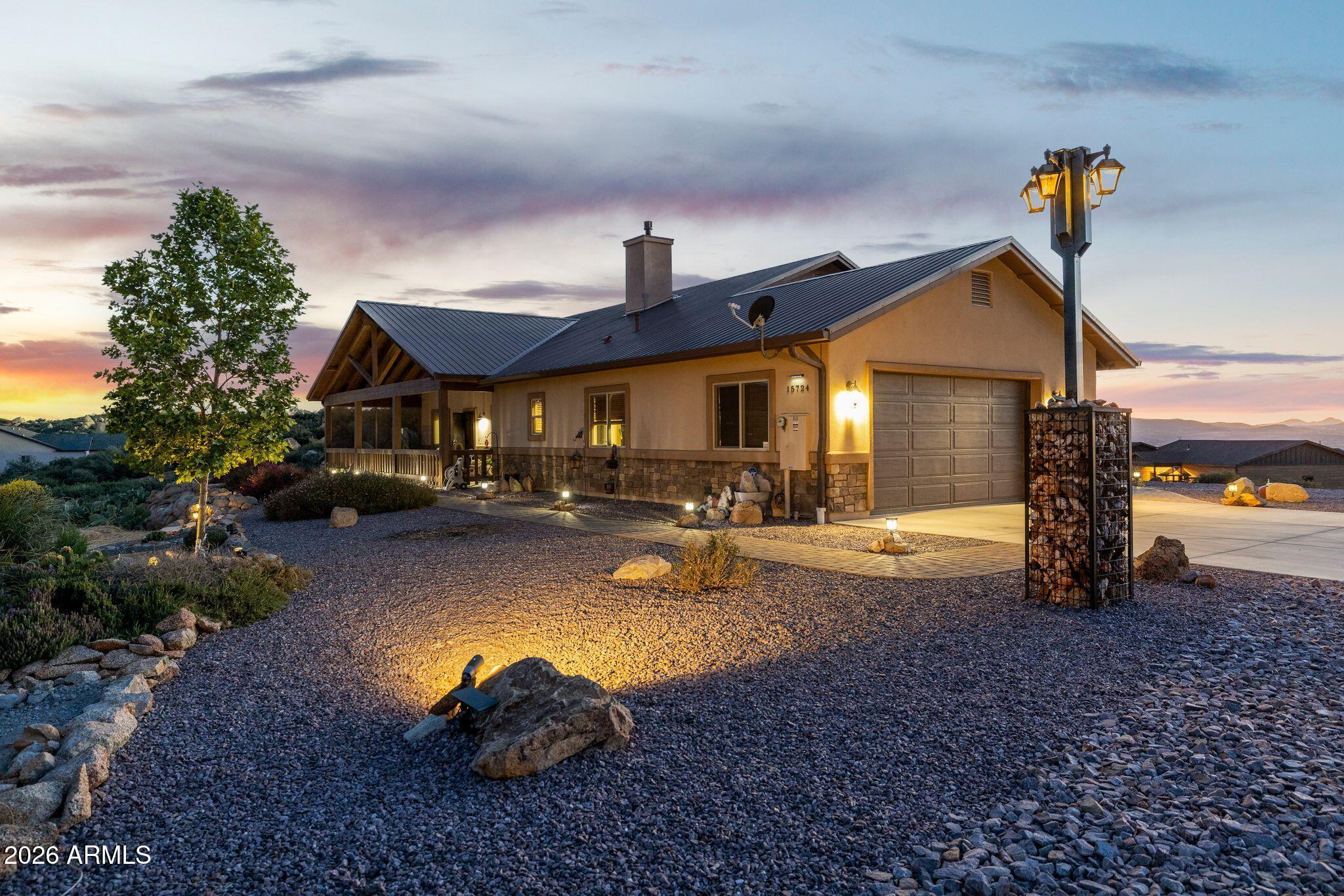 Cherry Hills Estates is where you will find this beautiful 3 bedroom, 2 bathroom 1847 sq ft single level home with Generac  propane powered backup generator for those just in case, once in a while power outages. The home sits on 2.005 acres of gentle sloping topography with 270 degree views for miles and miles. To the east from your front covered patio, you will enjoy those gorgeous sunrises with your morning cup of coffee. And then when the work day is done, go out to your fully screened in back patio, that is the full width of your house, and enjoy the western evening sunsets while sitting and relaxing or soaking in the included barely used hot tub. There is still plenty of room out there to entertain friends and family and just enjoy the peace and quiet that this home offers. The open main living area of this home features vaulted ceilings, large floor to ceiling gas fireplace with flagstone hearth and custom mantle, tongue and groove wood ceilings with recessed lighting and an open great room/kitchen design. Kitchen features include a large island, under and above cabinet lighting, upgraded countertops, hanging pendant lighting over island, knotty Alder cabinetry with glass fronts, soft close drawers and doors, stainless steel appliances, Kohler farmhouse style sink and a view that is stunning. The master suite is spacious with a great view and a bathroom with raised height double sinks, 3 head snail shower with floor to ceiling tile, walk in closet and a private water closet. The 2 other bedrooms each feature stunning views with one facing east and one west. Second bathroom has floor to ceiling tile in the tub/shower. There is an additional room off of the great room that was plumbed as a powder room with sink and toilet, but has been converted to a wine room. The laundry room with utility sink and cabinet storage is right in from the oversized 2.5 car garage with storage area to the side. There also is a 10' by 20' storage shed for additional storage and maybe a workshop. The large lot is expertly landscaped with natural native cacti, rock borders, boulder outcroppings, landscape lighting and enough vegitation to not even be able to see the house from the road. Very private. Home also features a blacktop driveway right to the concrete garage parking pad area with the room and power hookup for that RV. Paver walkways both front and back complete the beautiful exterior of this one of a kind home. Put this home on the top of your list to see today, but the best time to see it for the full experience is right at sunset.