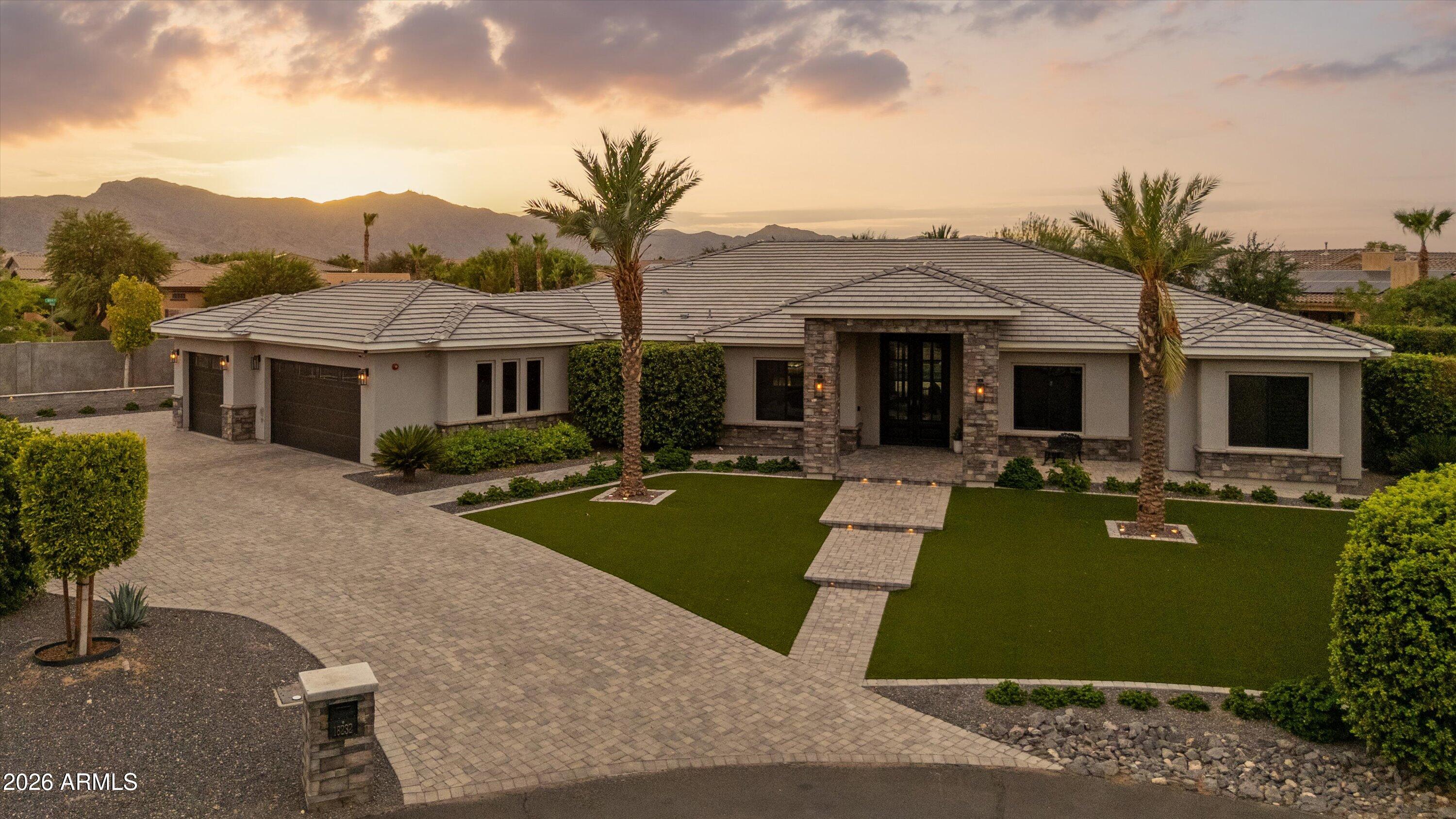 Welcome to this beautifully designed custom home in the highly sought-after gated community of Russell Ranch, where luxury, comfort, and thoughtful design come together. Situated on an oversized cul-de-sac lot, this exceptional property offers added privacy and one of the community's most peaceful settings.

Featuring 4 spacious bedrooms, including two with en-suite bathrooms, and 4.5 baths, the open-concept floor plan showcases premium finishes throughout. Custom cabinetry, quartz countertops, marble-tiled showers, and designer tile flooring create an elegant yet inviting atmosphere.

The chef's kitchen is the heart of the home, complete with a massive 11-foot island, stainless steel appliances, gas range, and stunning RH designer pendant lighting. The spacious living room features a sleek electric fireplace and an impressive stackable sliding glass door that seamlessly blends indoor and outdoor living.

Retreat to the luxurious primary suite with its spa-inspired marble bathroom and private access to the resort-style backyard. Outside, mature Ficus trees surround the property, creating a rare sense of privacy and tranquility while framing the sparkling pool and beautifully landscaped outdoor living spaces. The oversized cul-de-sac lot provides the perfect setting for entertaining or simply enjoying the peaceful surroundings.

From its thoughtfully curated design and premium finishes to its exceptional lot and serene outdoor oasis, this is a rare opportunity to own one of Russell Ranch's finest custom homes.