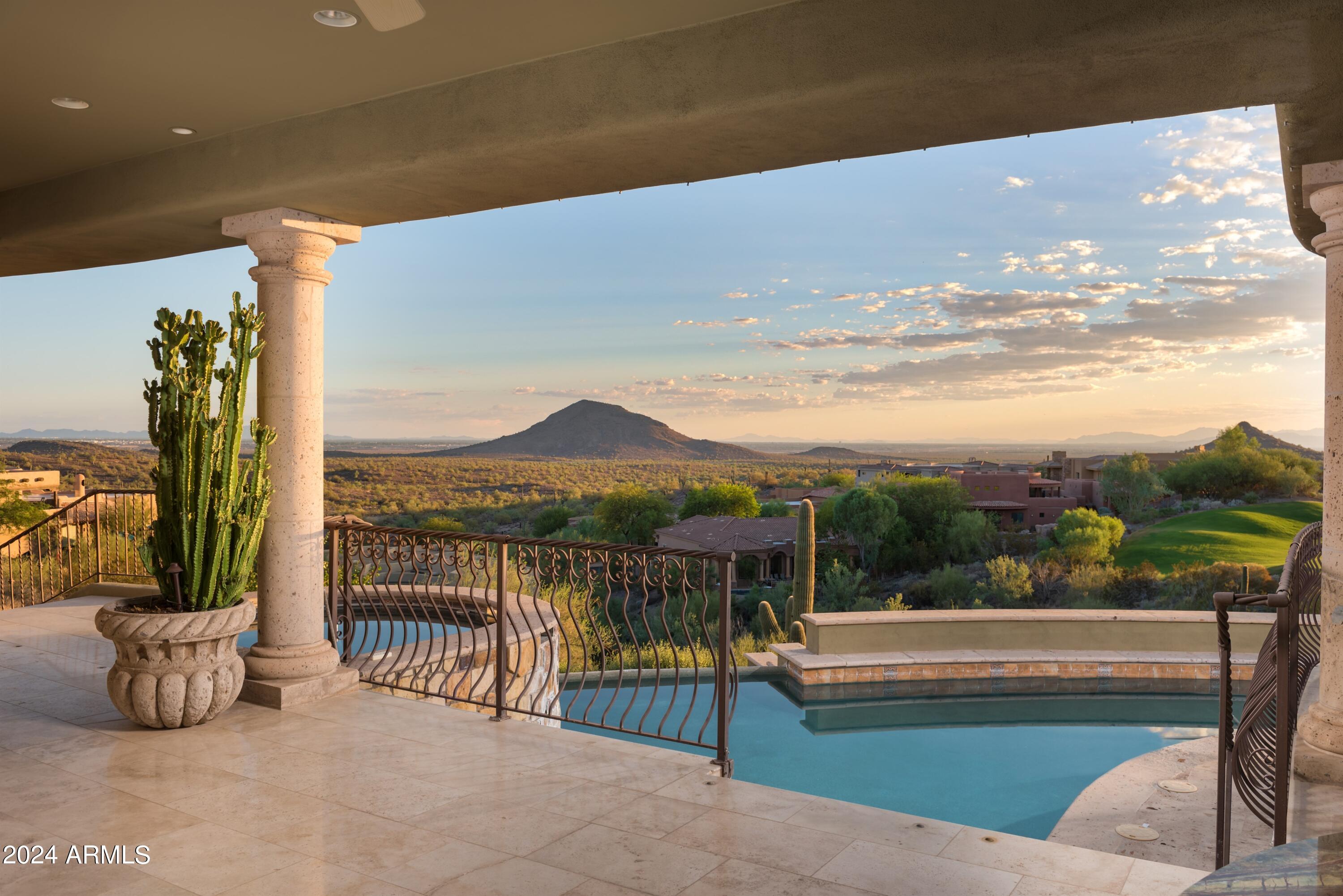 A rare single level find within the guard gated community of Eagle Mountain.  Pass through the tranquil and private courtyard to a stately foyer and let your emotions be stimulated by the ''WOW'' factor.  An exceptional Valley scene is  visible through a wall of pocketing glass doors.  The captivating view from a 1255 SQFT covered patio is unlike any other. 180 degrees of night city lights, an emerald fairway, and unspoiled desert/mountain scapes by day.  Paradise with pool and spa. Lovely moments will be experienced  in the grand dining room  with walk in wine cellar and a butler's pantry. Open to the kitchen, the inviting great room has two additional walls of pocketing glass. An exquisitely finished guest home features a living room, ensuite bedroom, dining and kitchenette details & cantera fireplace. The kitchen is a true culinary paradise with an oversized breakfast bar, stunning wood butcher island, rich cabinetry, double ovens, copper stove vent, pot filler, & more. Unparalleled rejuvenation is easily achieved in the master retreat, complete with a wall of butted glass windows, incredible ceiling stenciling, sitting area, private patio access, coffee/wine bar, dual raised vanities, regal soaking tub, and a European walk-in closet with many concealing doors. Just off the courtyard, a large office/den/media room is perfect for conducting business or enjoying a film. Completing the main level, two oversized en-suite bedrooms with private patio access and an incredible laundry/craft/sewing room are truly one of a kind. Separate from the main house, the casita features a large living room with kitchen and a large en-suite bedroom. Perfect for any Sonoran Season, the oversized backyard patio is a true oasis with a stunning pool, spillover spa, a misting/pool fogger system, integrated lighting and music systems, private pool bathroom, along with lush foliage. Hidden features of this home include 2 fully air-conditioned storage rooms, whole home lighting system with one button off, programable instant hot water delivery systems throughout the house and a galley butler's pantry with Ice maker, dishwasher, and refrigerator.