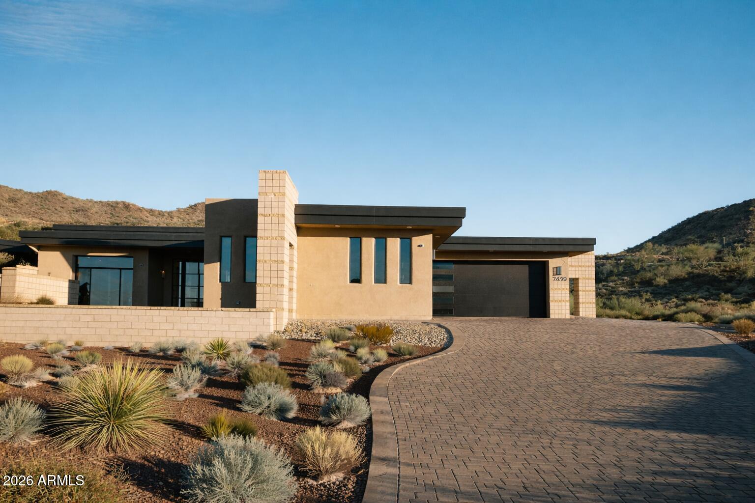 Located within the prestigious gated enclave of Estates of Tramonto / Ponticello, this custom estate redefines luxury desert living. Designed with meticulous attention to detail, the single-level residence spans 4,747 square feet and showcases architectural brilliance, refined elegance, and seamless integration with the Sonoran landscape.
Resting on a 1.06-acre homesite, Lot 16 is thoughtfully oriented to its north-facing vantage point, capturing sweeping views of the untouched Sonoran Preserve and surrounding mountains--framing both sunrise and sunset vistas. Modern design harmonizes with tranquil desert surroundings, offering a rare combination of sophistication and serenity.
The home's design blends beauty with function. A seven-car garage provides ample space for collectors and enthusiasts, while expansive outdoor living areas are anchored by a resort-style infinity pool that appears to merge with the desert horizon. A custom putting green completes the grounds, providing recreation and leisure in perfect balance with the natural setting.
Ponticello itself is an exclusive sanctuary of only 24 estates, accessible by a private bridge that creates a sense of arrival unlike any other. The community is designed to blend seamlessly with the desert terrain, delivering unmatched seclusion and privacy while remaining just moments from urban conveniences.

*Awarded "Best Home on Tour" by WeSERV (West & Southeast REALTORS® of the Valley) for "Best Presentation and Value."