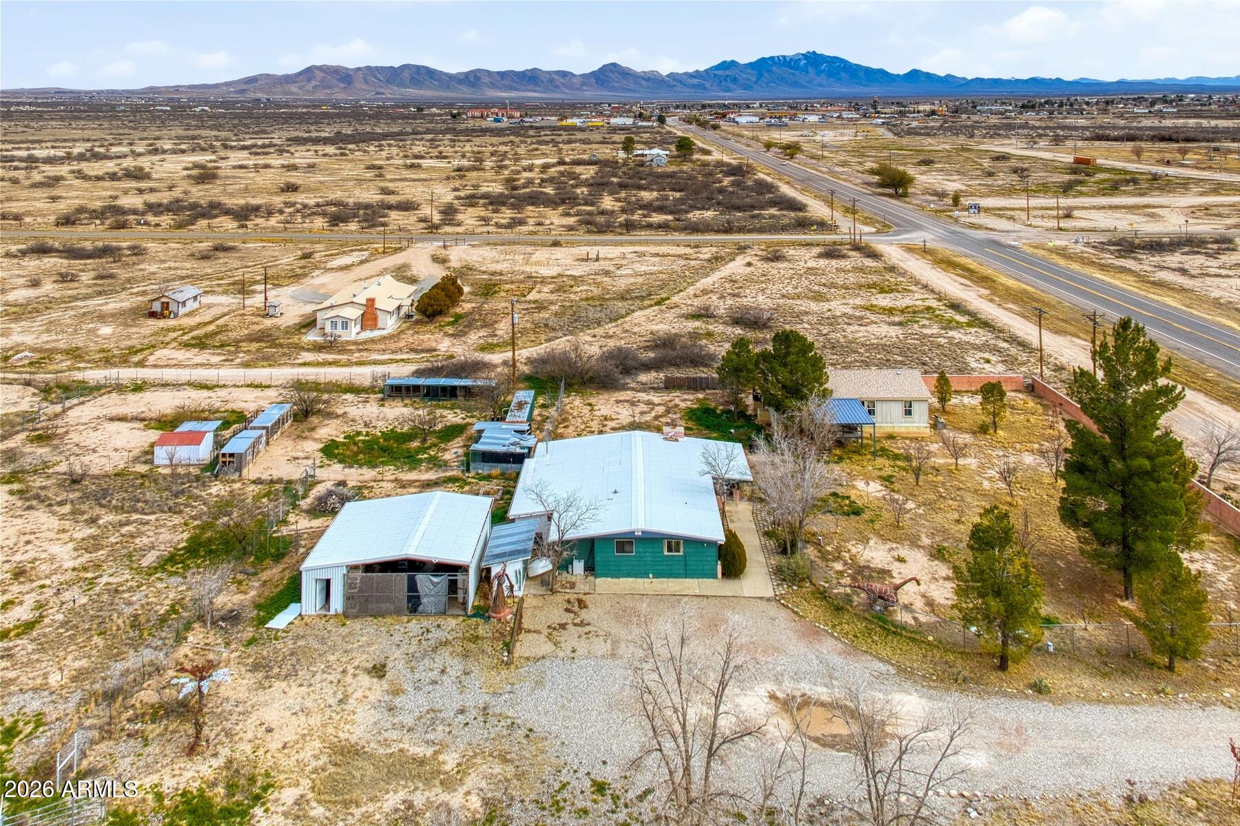 Unique live/work opportunity on 3 acres in Willcox, AZ. (additional Photos to come) Property includes a 2013 Manufactured Home 1104 sf with 3 bedrooms, 2 bathrooms & the original home - 1,907 sq ft, built in 1981 that has been converted for use as a veterinary clinic and is not currently configured as a residence.( was 4 bedrooms, 2 bathrooms with Kitchen, Laundry, enclosed porch, indoor kennels and storage rooms, site built, metal roof, fireplace) The property features cross-fencing, perimeter fencing, a large metal two-car carport with concrete slab, multiple storage areas, and multiple kennels. Two wells serve the property - 1 servicing the home and converted structure & 1 can be used for outdoor watering. Multiple Fruit Trees. Zoned RU-2 allowing residential and commercial uses. Original Home was converted into a Vet Clinic has metal roof.  Can be restored by adding in closets, installing kitchen and renovation of hall Bathroom. Only 1 of the 2 wells is registered -  55-220369 3/4/2011 - Depth 95'/ Static 60' / Hole Diameter 8". Appointments must be made to view the Home with the Listing agent present for access to property.  NO keys will be given out, Security cameras all over. Manufactured Home will be affixed through contract and before Close of Escrow to meet lending requirements.