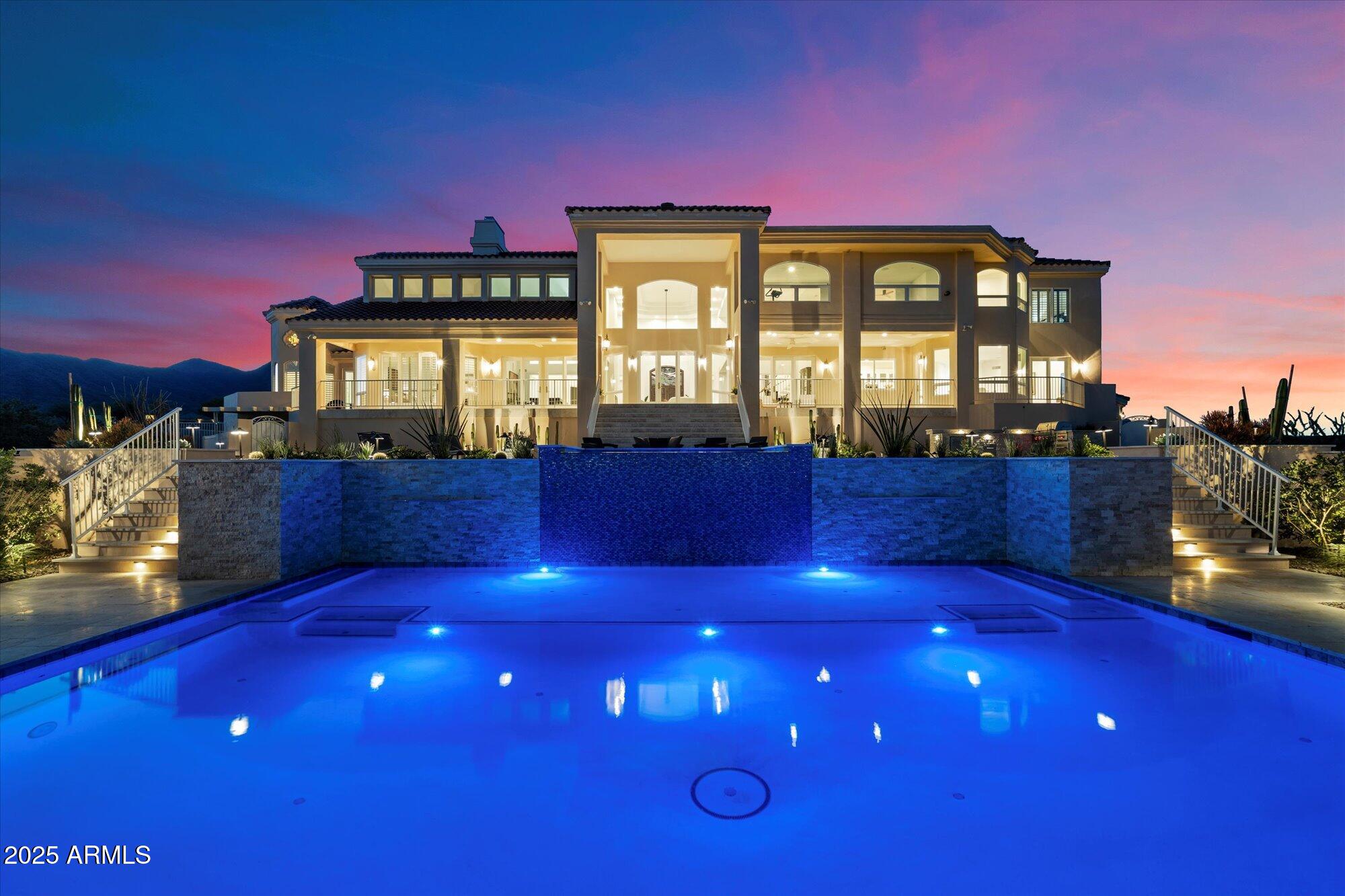 Unmatched Views • Timeless Architecture • Modern Desert Luxury. Perched high above Fountain Hills, this extraordinary Santa Barbara-style estate captures breathtaking panoramic views of Red Rock, Four Peaks, the Fountain, Weaver's Needle, the McDowells, the Superstitions, and the Mazatzals. Originally designed by award-winning architect Hassan Jalaly, this custom residence underwent an extensive remodel in 2025, blending classic craftsmanship with refined modern upgrades. The result is a perfect harmony of elegance, comfort, and cutting-edge technology.  The residence commands a rare 22-acre estate, offering a level of privacy and potential that is virtually impossible to find in today's market. These vast grounds ensure your sweeping vistas remain unspoiled and protected forever. The land is zoned for horses and provides the ideal setting to create a premier equestrian compound or even your own private par-3, 4 and 5 golf course. This is a unique opportunity to shape the land into your personal vision of desert luxury.

Inside, soaring ceilings, stone and wood flooring, and walls of glass fill the 6,215-square-foot floorplan with natural light. The grand living and dining spaces share a dramatic floor-to-ceiling two way fireplace with designer tile that embodies delicately balanced movement, creating a warm and sophisticated focal point. The kitchen is a true chef's delight, featuring marble countertops, premium Kohler fixtures, luxury Monogram appliances, dual stainless sinks with reverse osmosis, and an inviting breakfast nook that perfectly captures the morning sun.

The main-level primary suite serves as a peaceful retreat with a wood burning, gas fireplace, cozy sitting area, and direct patio access. Its spa-like bath offers dual vanities, a jetted soaking tub, custom cabinetry, and the Kohler DTV digital shower system for an elevated experience. Upstairs, a private guest suite with a full wet bar and family room provides the ideal space for visiting family or friends.

Every inch of this home reflects quality. The 2025 remodel introduced new flooring and fixtures throughout, complemented by a whole-home automation system, surround sound, security cameras, four zoned HVAC units, and a complete sprinkler system. Outside, a brand-new pool and spa anchor the spacious backyard, surrounded by professional landscaping and a full-length tiled veranda for dining and lounging. From sunrise over Four Peaks to starlit evenings by the pool, 16400 N Log Ln offers the very best of Fountain Hills.