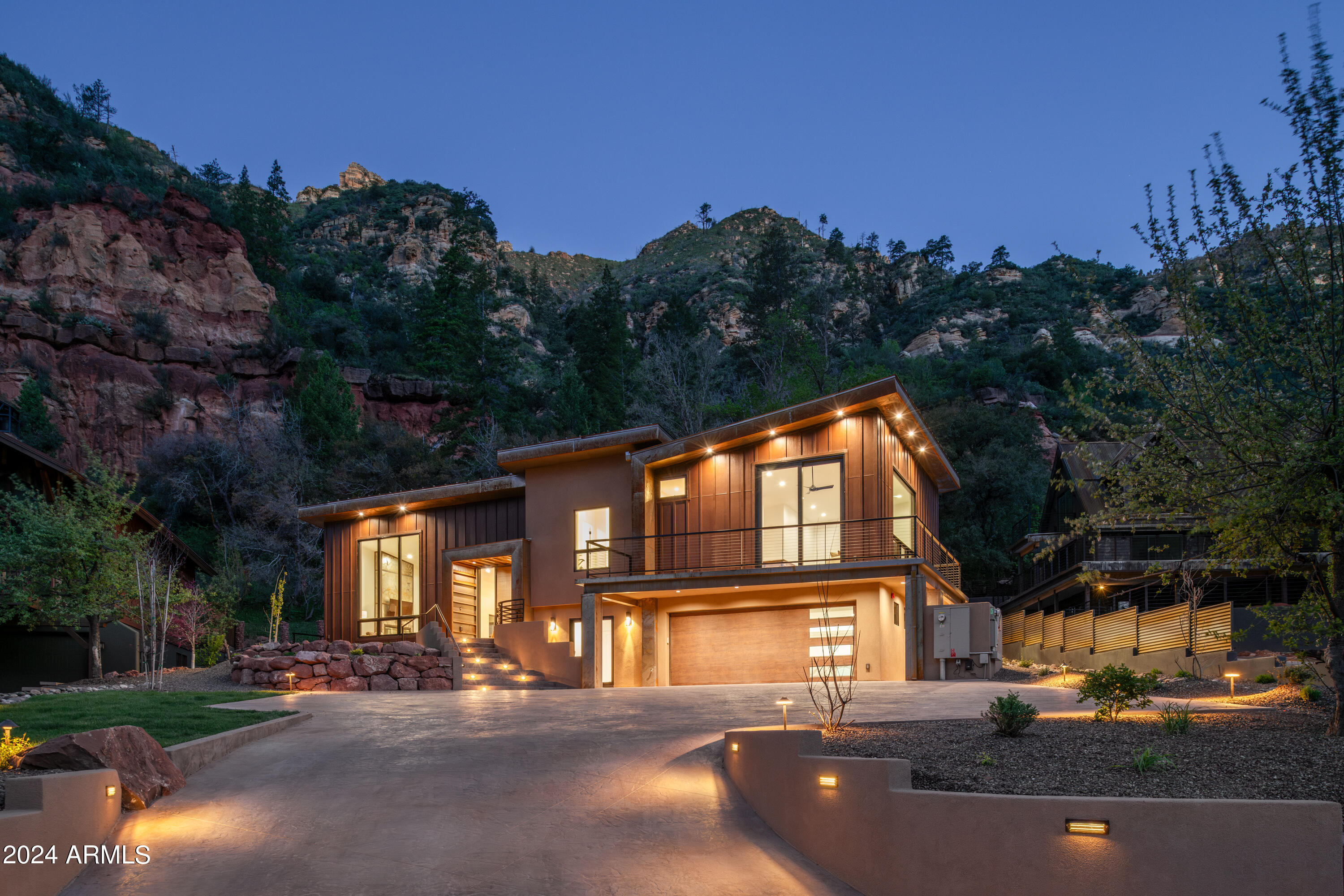 Welcome to Oak Creek Canyon's brand-new 2024 construction, fully furnished and showcasing impeccable craftsmanship! This exquisite 5 BD, 4.5 BA residence combines modern-rustic architecture with high-end designer appointments, creating a home that harmonizes beautifully with Sedona's breathtaking outdoor elements. With solar power, a premium metal roof, and lushly landscaped grounds featuring a water feature and brand new 2025 Pergola in the back yard! This property blends elegance with sustainable living. An in-law apartment with two bedrooms, a kitchen, and a bath provides endless flexibility. Buyer customization renderings also include an optional heated spa. This community, with private creek access, an apple orchard, and direct trails to West Fork, offers both tranquility and luxury. Inspiration Behind the Design: The redesign of this home in Junipine Estates draws inspiration from the natural beauty of Oak Creek Canyon, with a vision to showcase its stunning ridge lines and Red Rock landscapes. Originally an A-frame structure with small windows and a choppy layout, the home has been transformed into a rustic modern retreat. Expansive windows invite the breathtaking surroundings inside, while classic touches like wood flooring and stone accents maintain its timeless appeal. Sustainable elements, including solar power, were integrated to enhance environmental efficiency and seamlessly blend the home into its natural setting. Starlink Wi-Fi was added to meet the demands of remote work, making this home ideal for today's lifestyle. The exterior color was thoughtfully chosen to blend harmoniously with nature, creating a true sanctuary.

Living in Junipine Estates: Nestled within a private, gated community, Junipine Estates offers an unmatched combination of tranquility, privacy, and a deep connection to nature. Its serene environment is perfect for those seeking a peaceful retreat, with uncrowded hiking trails and refreshing swimming holes in the creek during summer. Residents can also enjoy fishing, thanks to the creek that winds through the area. The climate is notably cooler than nearby Sedona and Phoenix, providing year-round opportunities for outdoor adventures along Oak Creek. The canyon's exquisite beauty, dark skies ideal for stargazing, and peaceful surroundings encourage a relaxed and fulfilling lifestyle.