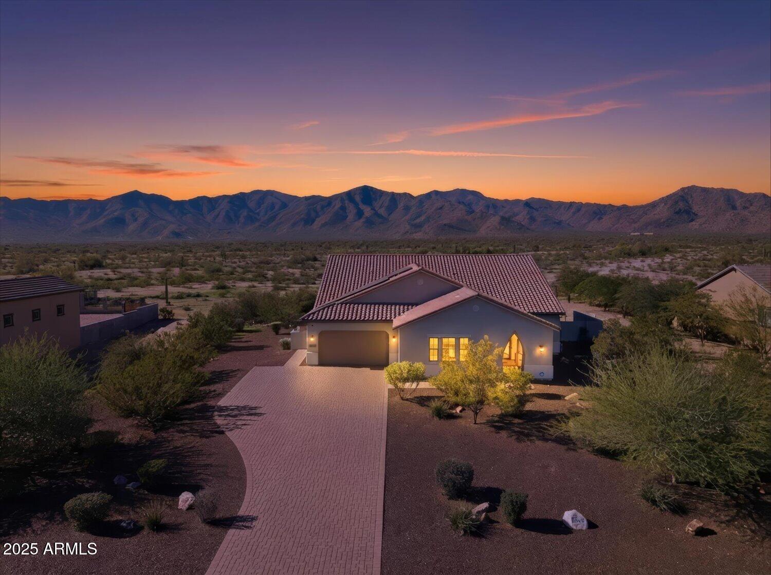 MOTIVATED SELLER! PRICE REDUCED $40K- Seller willing to offer concessions. Nestled at the base of the stunning White Tank Mountains and bordering State Trust land, this beautifully designed 3-bed/3.5 bath home offers the perfect blend of space, style and Arizona outdoor living. The open-concept floor plan is filled with natural light, highlighted with expansive full patio doors. THE large backyard features a covered patio, grassy area and splash pad - perfect for entertaining and relaxing year round. A spacious 3-car garage provides ample storage, while OWNED SOLAR and EV charge adds energy efficiency and long-term savings. Enjoy mountain views, thoughtful design and a prime location that captures the best of desert living.