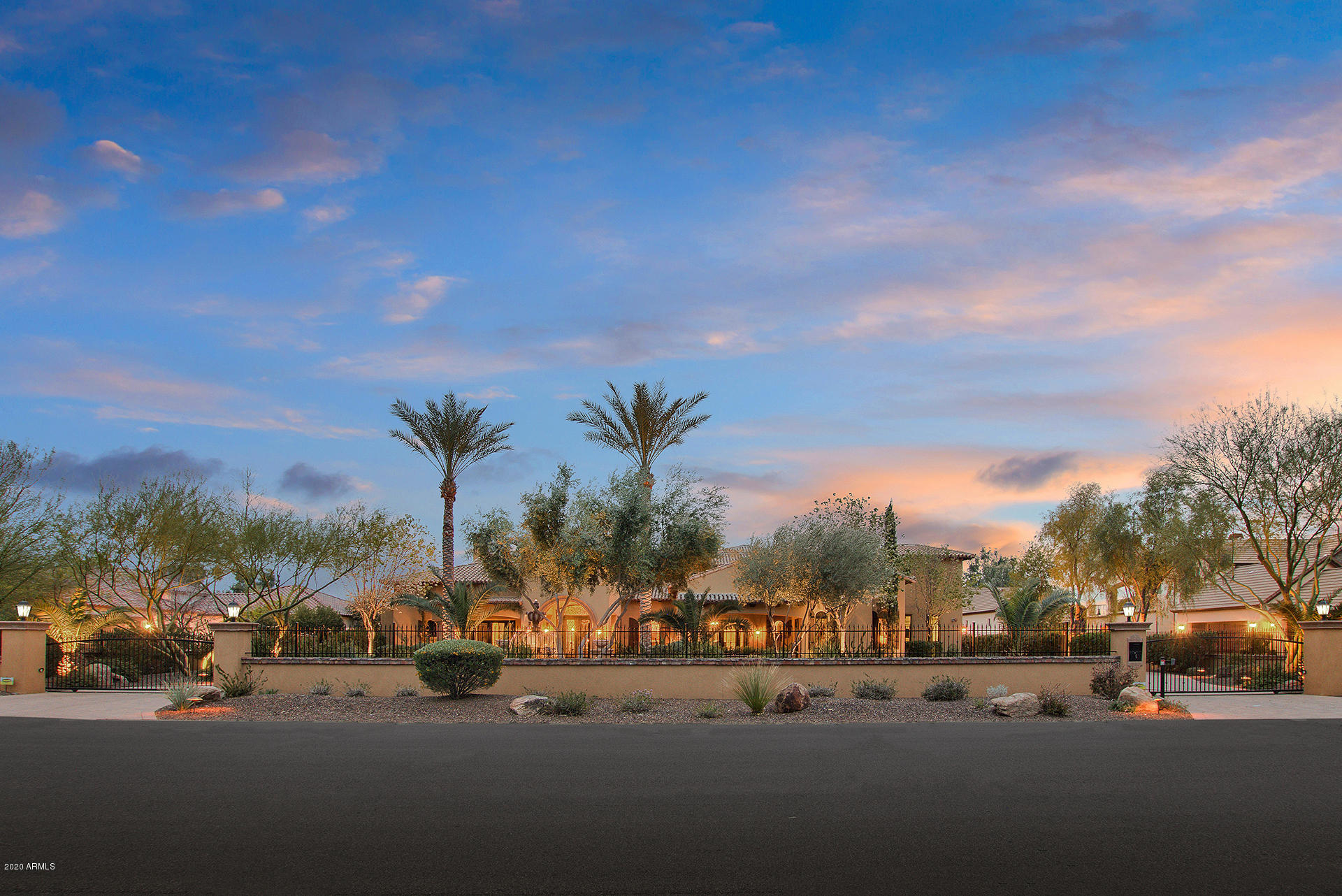 This RESORT STYLE LUXURY compound in the highly sought after Cactus Corridor is UNBELIEVABLE!   This home is the epitome of high quality craftsmanship with high-end finishes throughout.  Exquisite barrel brick flooring in entryway and barrel brick ceilings in entryway and breakfast room is a unique yet beautiful touch!  Home has an On Q Legrand Home Network System.  HUGE kitchen island is the centerpiece of this kitchen.  Second island has a breakfast bar for additional seating.  Chef's kitchen boasts, dual sub-zero, Wolf 6 burner gas range, butler pantry, multiple ovens and opens up to a LARGE breakfast room and oversized wood-beam ceiling family room.  For added privacy the master suite is situated in the back of the house.  Master retreat features his and her's separate bathroom areas and closets. A washer and dryer is conveniently located in Her's master closet.  Have the home gym you always wanted right off the master bedroom.  Do you enjoy reading?  Wall to ceiling bookshelves in the library/office will please any avid book collector/reader!  Your backyard oasis has every amenity you could imagine, including heated saltwater pool and spa with water feature, outdoor kitchen, Cabana with a TV and fireplace, misting system, bocce ball court, horseshoes, putting greens, grassy areas, WIFI accessible and LED lighting. You'll never want to leave this house!  In the Spring, there will be plenty of fruit to pick from your personal orchard, including mandarin orange, key limes and lemon trees.  Back inside the house, all bedrooms are ensuite with black walnut solid interior doors.  Enjoy weekly family movie night in the media room with surround sound or how about a game of pool?  5 fireplaces!  3 gas hot water heaters! 4 1/2 car garage with a urinal. Two washers and dryers in the laundry enable the family to easily keep up with all the laundry. Upstairs attic room (14 x 15) gives you approximately another 200+ square footage for storage.  This home checks all the boxes for even the pickiest buyer!  Check out the 3D Matterport virtual tour in the photos tab and floor plans in documents tab.