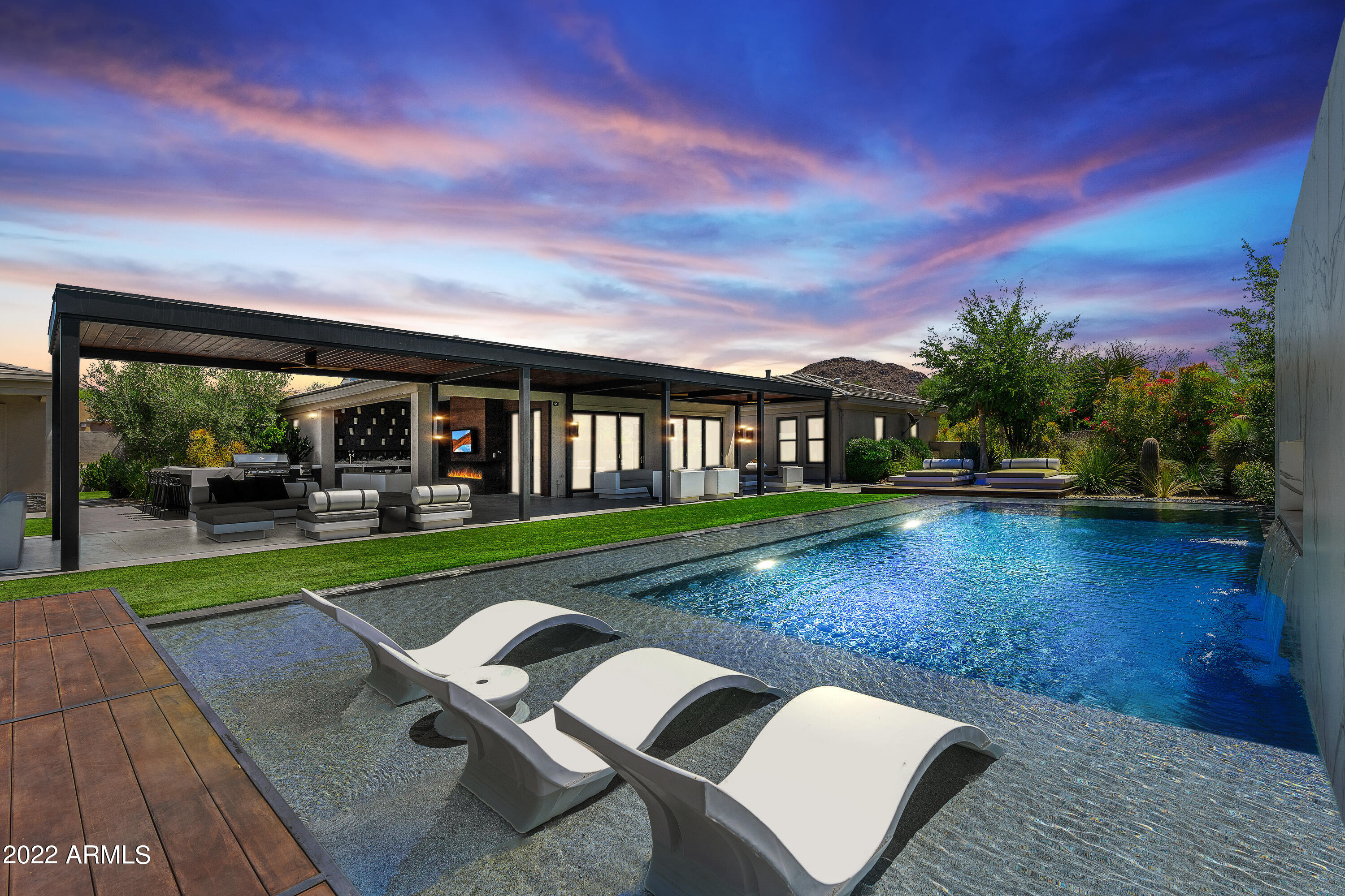 Exceptional and Newly Updated Home from the floor to the ceiling 2022, all designed by Peit Boon! Gorgeous Kitchen with Quartzite countertops, All New white cabinetry, Bosch appliances and Butler's pantry. Enjoy tons of Spacious indoor/outdoor Living areas complete with a Savant home automation system! Featured in Phoenix Home and Garden Magazine, an Incredibly Private backyard with Resort Style pool featuring several water features, Slide, Star Lights, Fire accents and Mountain Views from the raised Hot tub! Oversized Covered Patio Complete with Built-in Kitchen, Gas BBQ, Dekton surfaces, surround sound and industrial misting system. Separate Guest Quarters. The Ultimate Entertaining Experience! Private cul-de-sac lot.