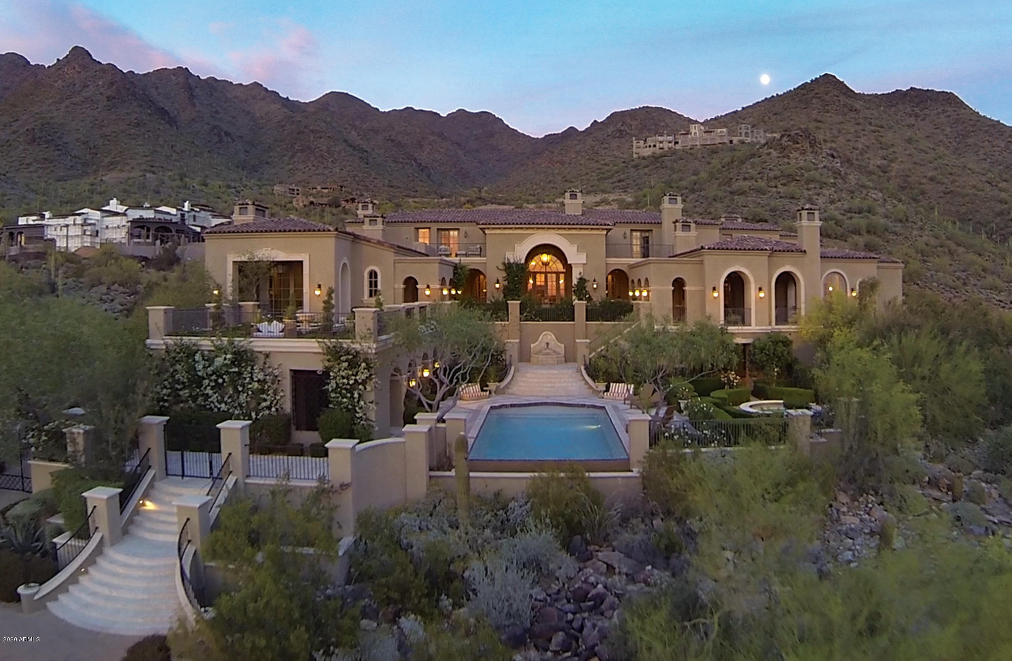 This majestic Country French 2 acre estate is situated in Silverleaf's Upper Canyon with city light and mountain views abounding from nearly every room. The 14,313/sf home encompasses 5 bedrooms, 8 bathrooms and a guest casita. You enter into a grand entry hall alongside a romantic staircase. This opens up to a posh living area adjacent to a luxurious wet bar with zinc counters all overlooking the covered patio and spectacular city light views. To the right is a formal dining room with limestone fireplace. The gourmet kitchen showcases Clive Christian cabinetry imported from England, zinc counters and top of the line appliances. The master suite includes a lavish bath, exercise room and sauna. The magnificent 2,000+ square foot office has reclaimed wood flooring from a French castle