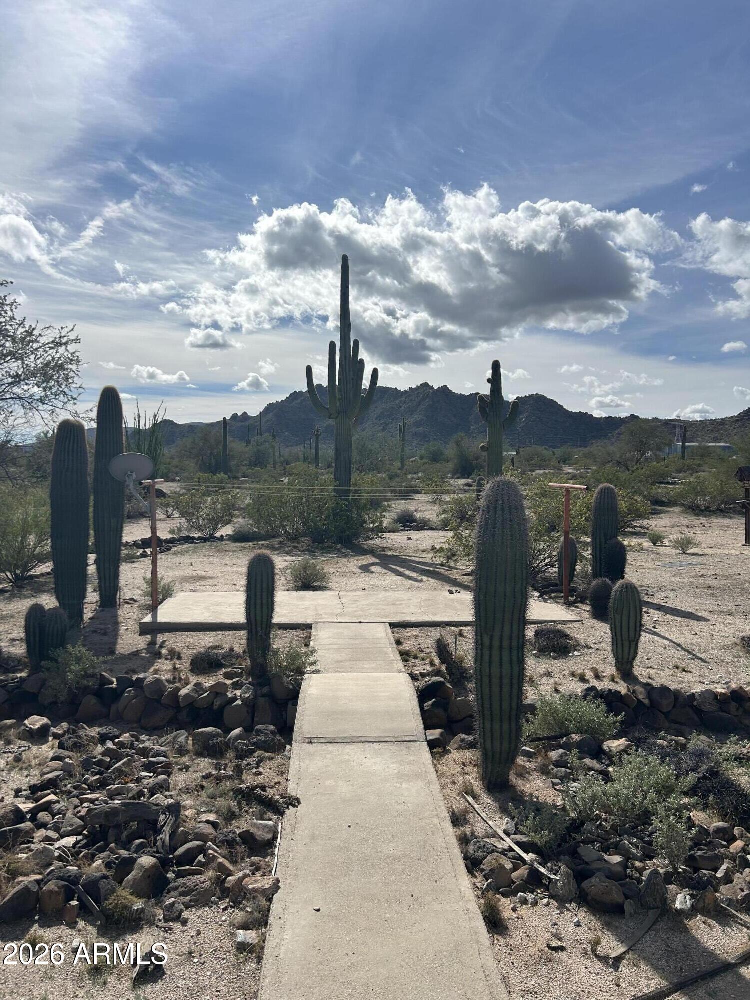 Amazing Investment Opportunity!
Own this 4-bedroom Redman home situated on 3.3 beautiful acres filled with stunning saguaros. Enjoy peaceful desert living from the full-length front and back porches--perfect for relaxing or entertaining.

Inside, you'll find a spacious great room with a breakfast bar, a split floor plan for added privacy, vaulted ceilings, and ceiling fans throughout.

The property features its own private well and a large 24x40 garage/workshop complete with a bathroom--ideal for hobbies, storage, or a home-based business.

This truly is a one-of-a-kind property with endless potential!