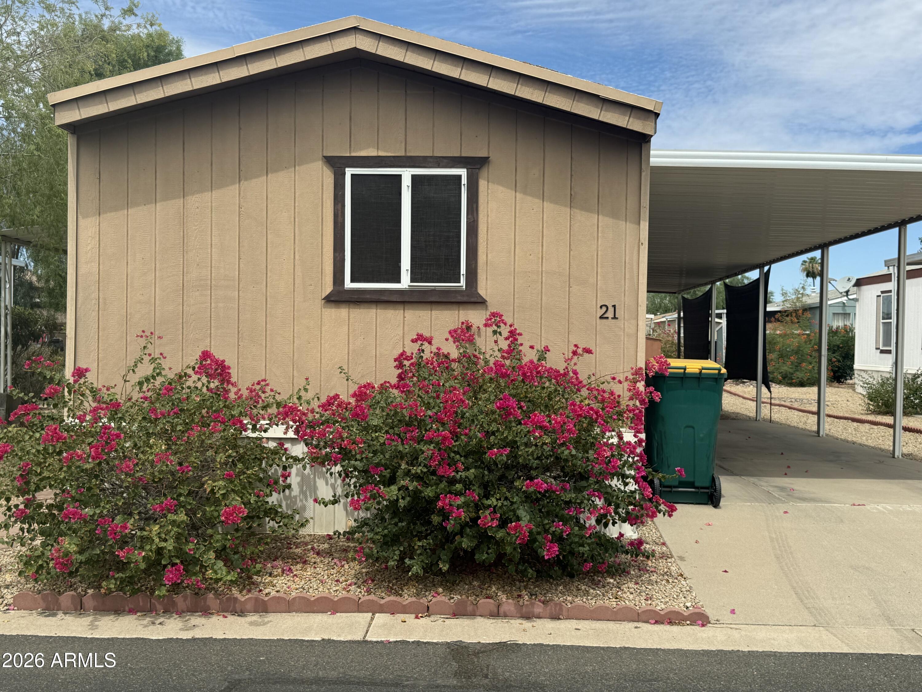 Pictures coming soon Come see this well-maintained age-friendly community. Residents enjoy access to amenities, including a community pool, recreation center, and fitness center. Inside, you'll find updated bathrooms! The kitchen includes all appliances, and the washer and dryer convey, making for a seamless move-in experience. Outside, enjoy a low-maintenance backyard, a large covered patio and a storage shed for added convenience. Ideally situated near shopping, restaurants, entertainment, and Luke Air Force Base. Buyer will need to be approved by park management.