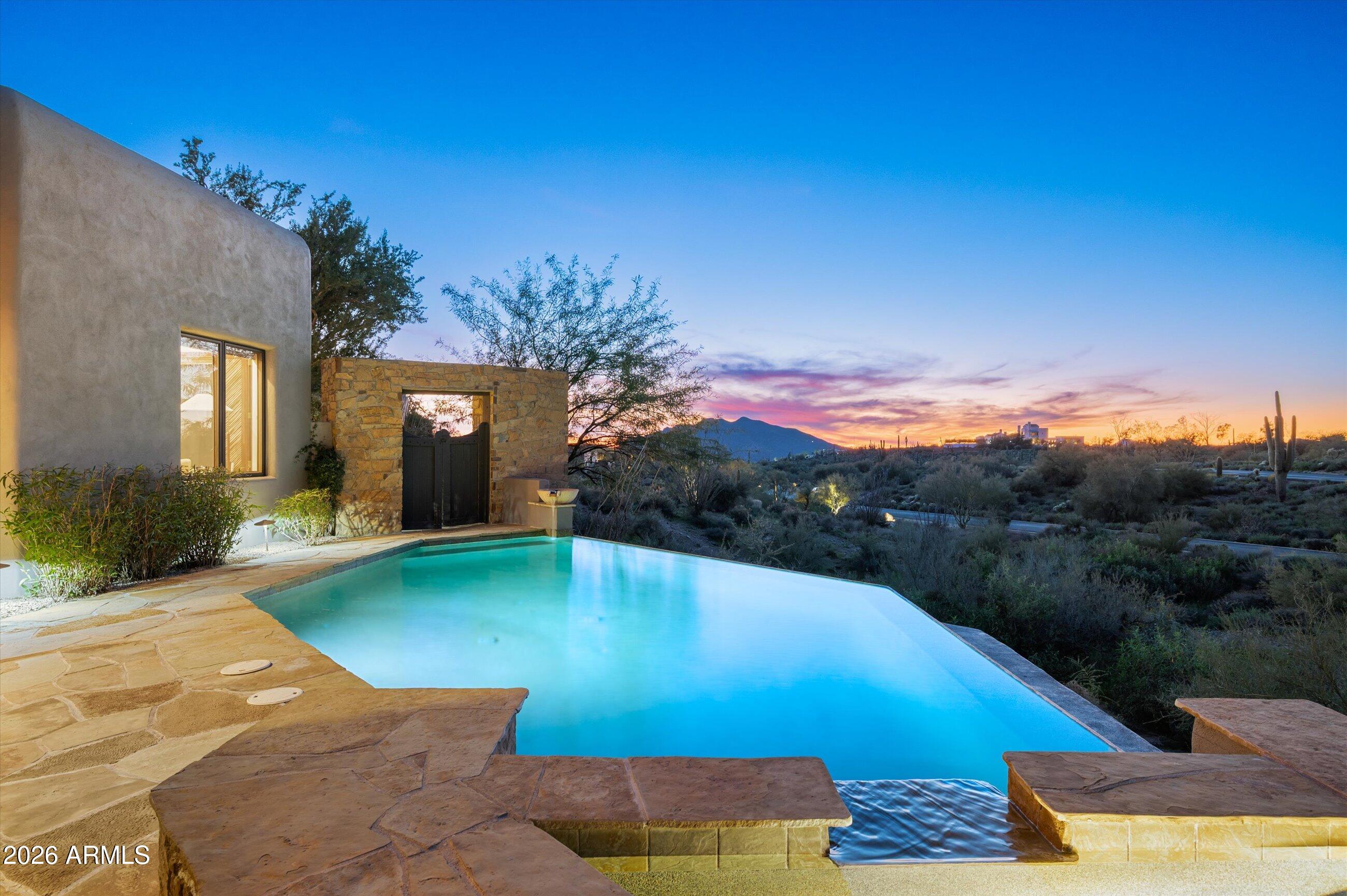 Desert Mountain Golf Membership Available. Warm Contemporary home located in Private Guard-Gated Desert Mountain Club in North Scottsdale. Designed by Tamara Pohle and built by Victor Wiger adjacent to 14th Green of Renegade Golf Course with Black Mt & Continental Mt Views just minutes from gate. Craftsmanship abounds with fine finishes & features throughout: Travertine Flooring, New Carpet, solid Alder 8' Doors & Cabinetry, Granite Countertops, Wet bar w/600+ bottle Wine Room connecting Living & Family Rooms. Casita Living room w/Kitchenette, En-suite Bedroom and Patio.  Perfect for entertaining with 3 Outdoor Patios includes Infinity Pool, Spa, Fire-pit, Fireplace, BBQ, & built-in Heaters. Home built on ridge to capture the vista's and offers privacy and a peaceful ambiance