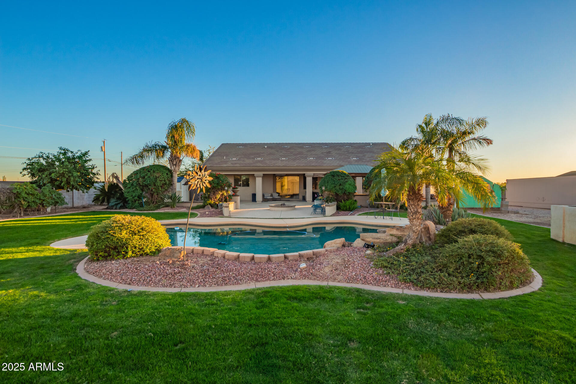 Experience exceptional living on nearly 1.5 acres with this distinctive 4-bedroom, 3-bath residence—perfectly designed for those who value both comfort and craftsmanship. The main home offers warm, inviting living spaces ideal for entertaining, along with a thoughtfully appointed kitchen ready for gatherings of any size.

The true centerpiece of this property is the extraordinary 4,000 sq ft detached garage and workshop (with separate septic tank) —a car enthusiast's dream. Featuring an oversized RV bay, a professional-grade lift, and ample room for multiple vehicles, this impressive space provides endless opportunities for restoration, storage, and hobby work . Also includes two additional rooms, 1.5 baths, offering flexible use as a private office, guest quarters, or relaxation retreat.

Step outside to enjoy a backyard built for year round enjoyment, complete with a sparkling pool and generous patio space perfect for outdoor dining, barbecues, and sunny afternoons spent with family and friends.

Ideally located near parks, local dining, and everyday conveniences, this remarkable property combines the freedom of wide-open space with the comfort of refined living. A truly unique opportunity for those seeking luxury, functionality, and the ultimate automotive haven.