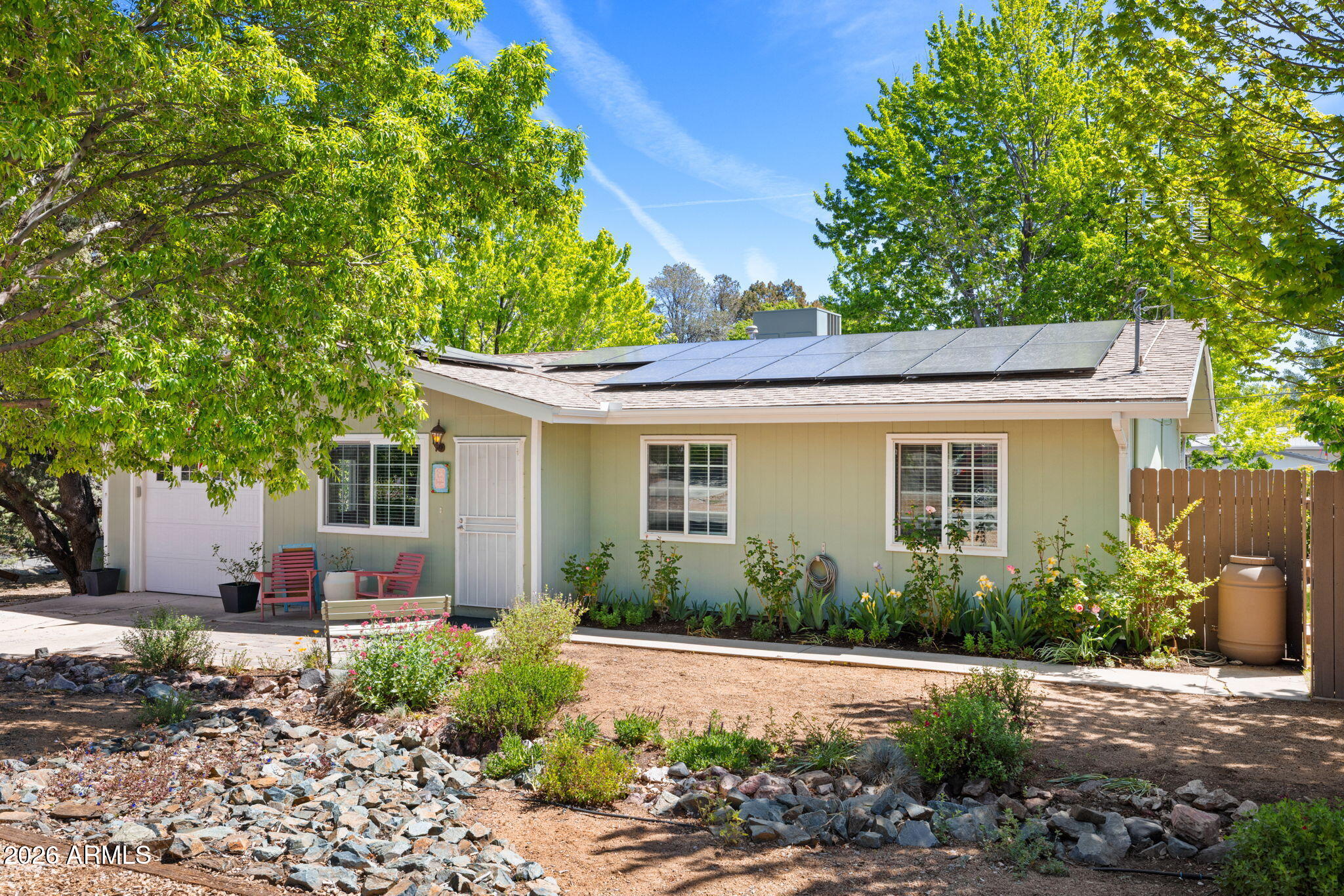 Welcome home! Charming, lovingly maintained property that truly shines inside and out! The outdoor space is a gardener's dream, mature trees, established landscaping, fruit trees, raised herb garden beds, a covered patio, and your very own greenhouse with electricity and water, perfect for year-round growing. Inside, the kitchen features quartz countertops, neutral cabinets, and consistent flooring throughout, all bathed in natural light from large dual-pane windows. Ceiling fans and generous storage complete the picture. A detached storage building with electricity adds incredible versatility, and the washer, dryer, and refrigerator are all included for a truly seamless move. Located in a quiet, established neighborhood with a genuine sense of community. Move in ready-don't miss it!