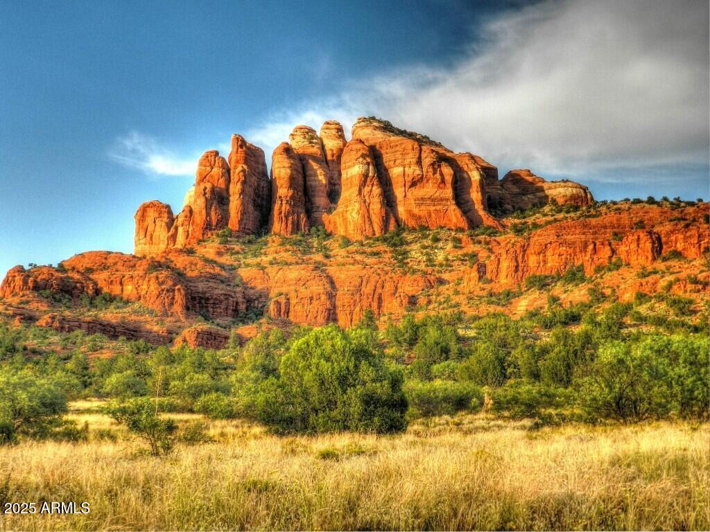 One of the best and most viewtiful lots in CR Ranch. Cathedral Rock and Seven Warriors Mesa red rock mountain range are unobstructed. This is a big 1 acre lot and owner has already done ALL the preliminary work.  Perc test, topo survey, tree survey and soils expansion test are done, see them in Documents.  House plans that Seller had designed are included. Lot is mostly level for easy build. Your are just 10 minutes from shopping, medical services and golf in VOC and 25 minutes to Sedona.  Here you have peace, quiet and dark night sky you didn't know existed.