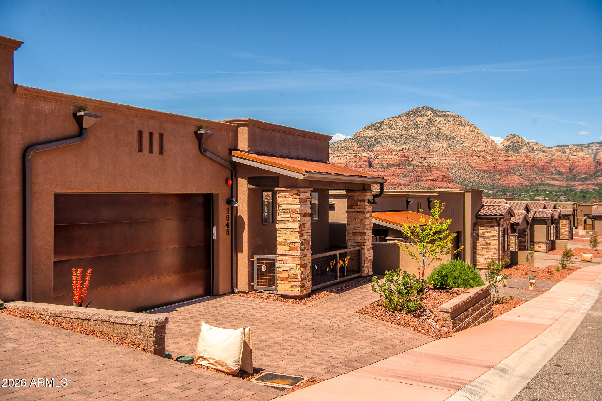 Turn-key Sedona retreat with truly breathtaking, unobstructed red rock views, this thoughtfully designed 2-bedroom, 2.5-bathroom home offers a modern, open layout that perfectly captures the beauty of its surroundings from nearly every room. The expansive kitchen is centered around a massive island with a farm-style sink, offering plenty of space for cooking, gathering, and entertaining, all while enjoying panoramic views of Sedona's iconic red rock formations. The large living room is filled with natural light and positioned to showcase the scenery, seamlessly flowing onto the back deck where indoor-outdoor living comes to life. Step outside to a private outdoor oasis featuring a built-in fire pit and tranquil fountain, the perfect setting to unwind, entertain, or simply take in the ever-changing colors of the red rocks at sunrise and sunset.

Both bedrooms are generously sized, with the primary suite offering stunning red rock views, a spacious walk-in closet, and a well-appointed bathroom complete with a double vanity and walk-in shower. The second bedroom also provides ample space for guests or a home office, while both bathrooms feature sleek walk-in showers and modern finishes. Designed to maximize comfort, light, and scenery, this home offers a rare opportunity to experience Sedona's natural beauty from the privacy of your own space. Whether you're looking for a full-time residence, vacation getaway, or investment opportunity, this property delivers an unmatched combination of style, functionality, and world-class views.