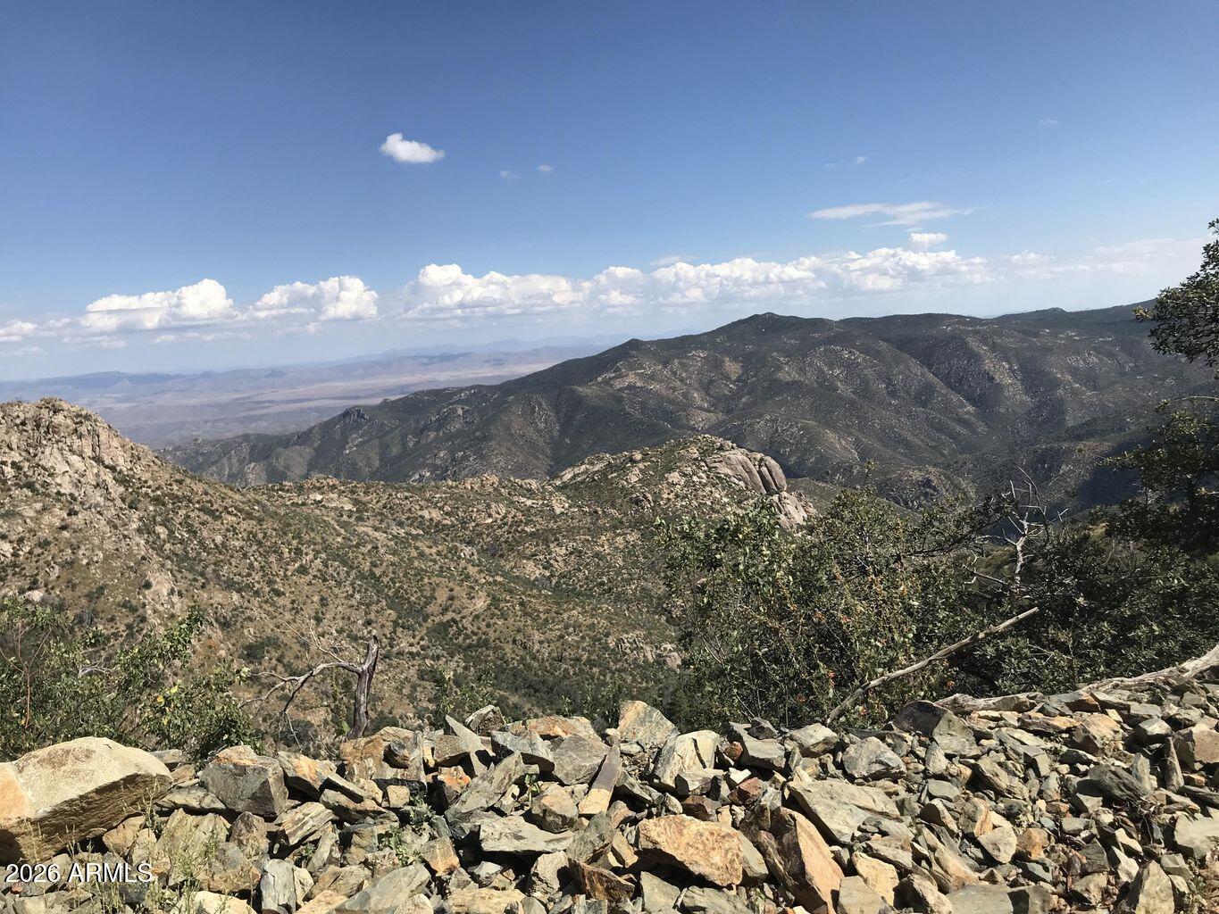 Rare opportunity to own two parcels of land in the heart of beautiful & historic Crown King, AZ, offered together as one sale. Parcel #204-04-027R & #204-04-027Q are included & must be sold together. The road has already been graded & a building pad is in place, making this property ready for your vision. Perched above the canyon, these parcels offer breathtaking panoramic views overlooking the rugged landscape below w/ the charming town of Crown King nestled among the pines. Surrounded by Pinyon Pine & Juniper trees, this property delivers true mountain living w/ privacy, scenery & serenity. Enjoy the cool mountain air, peaceful atmosphere & unmatched tranquility of the Bradshaw Mountains; perfect for a custom cabin, weekend retreat, or full-time mountain escape. Build your dream home & & make this exceptional property your own in one of Arizona's most unique & historic mountain communities!