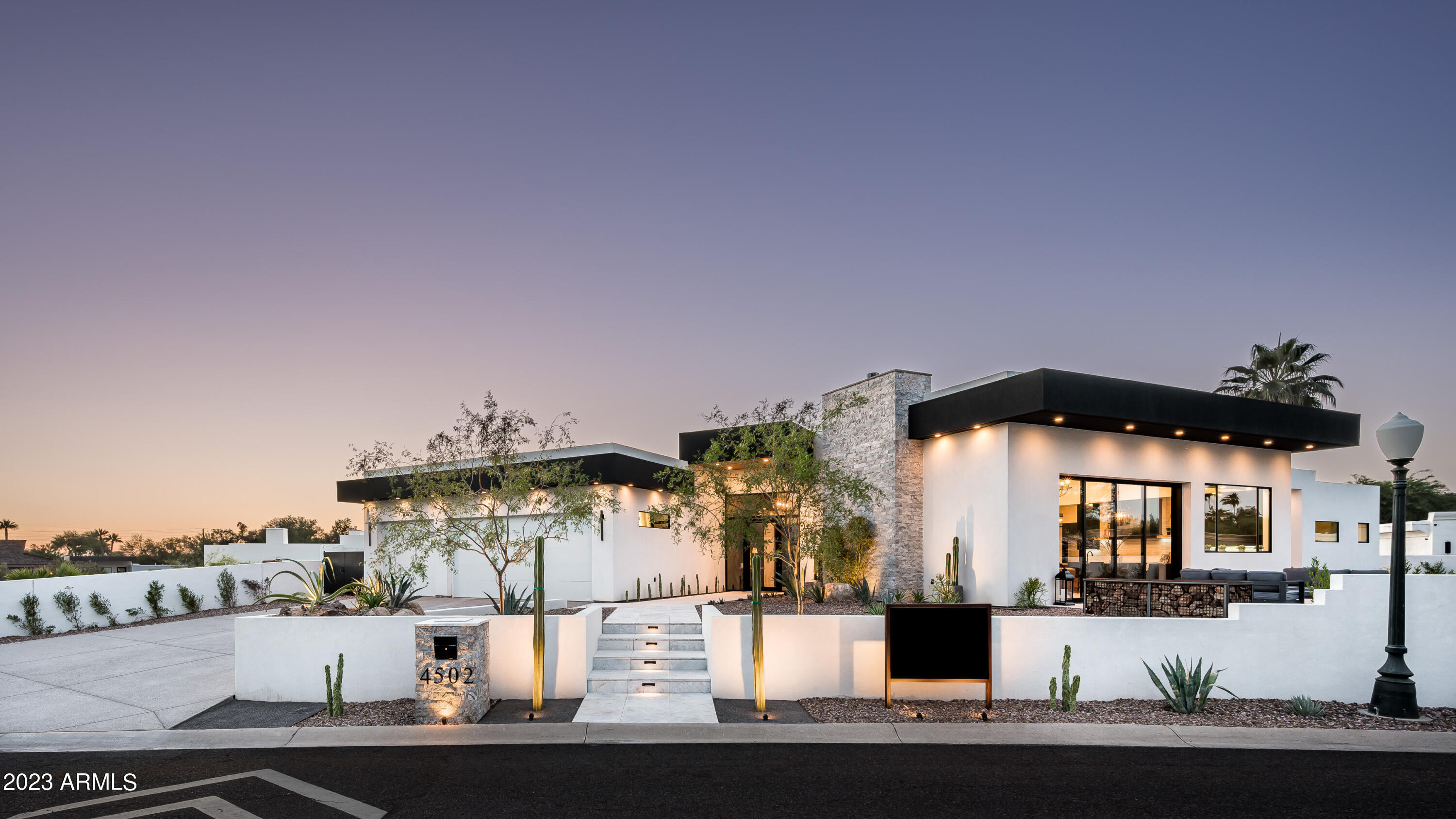 Elegant summer escape to your ultimate retreat. This stunning newly constructed property nestled at the base of Camelback Mountain, perfectly situated between the desirable neighborhoods of Arcadia and Paradise Valley. This exceptional home, known as Solano, offers a wealth of luxurious features and an impeccable attention to detail, making it an ideal retreat for those seeking a contemporary and easy living lifestyle.

This 4,387 square foot home offers a thoughtfully designed split floor plan with 5 bedrooms, 5 full bathrooms, powder room, and an exterior pool bath with shower. The chef's kitchen is a true highlight, featuring dual dishwashers, double kitchen sinks, 48-inch dual  fuel Monogram appliances, and of course a large butler's pantry for extra storage, and food preparation Natural light warms every corner, and natural hardwood flooring extends throughout the entire home, and the custom design package by Becky Pryor will have you taking pictures to share with friends and family from your first visit. The primary bedroom is split from the secondary bedrooms for ultimate privacy, including a spa steam shower, large walk-in closets, and spa-like features to finish the bath.

The star of the show is the home's magnificent views. Whether you're relaxing in the front or rear of the property, you'll be treated to breathtaking vistas of Camelback Mountain, the Praying Monk, and Piestewa Peak. The location within the quiet Camelback Canyon Estates neighborhood ensures tranquility and privacy, with common area spaces between residences, and this lot is conveniently situated next to one of them.

As you peel back the layers of this thoughtful build, you'll discover a home designed with comfort and efficiency in mind. High-efficiency spray foam insulation ensures optimal energy savings, while the oversized lot and north/south exposure provide ample space and natural light. The resort-style pool and jacuzzi, heated by natural gas, offer a perfect oasis for relaxation. The exterior offers a deluxe bar counter/cooking space, complete with a BBQ, sink, multiple drawers, and a beverage fridge, perfect for entertaining guests.

Technology and automation are seamlessly integrated into the home, with a Lutron lighting system that automatically adjusts based on the sunset and sunrise, an integrated sound system, security features, thermostatic control, and a home automation system with a color touch screen for easy access and control. The property also features a gigabyte network router and switch, a mailbox column with LED transformer for landscape lighting, and a lighted high-security mailbox.

With its unparalleled views, luxurious amenities, and smart home technology, this property at the base of Camelback Mountain is an exceptional find. Don't miss your opportunity to own this masterpiece of modern living.