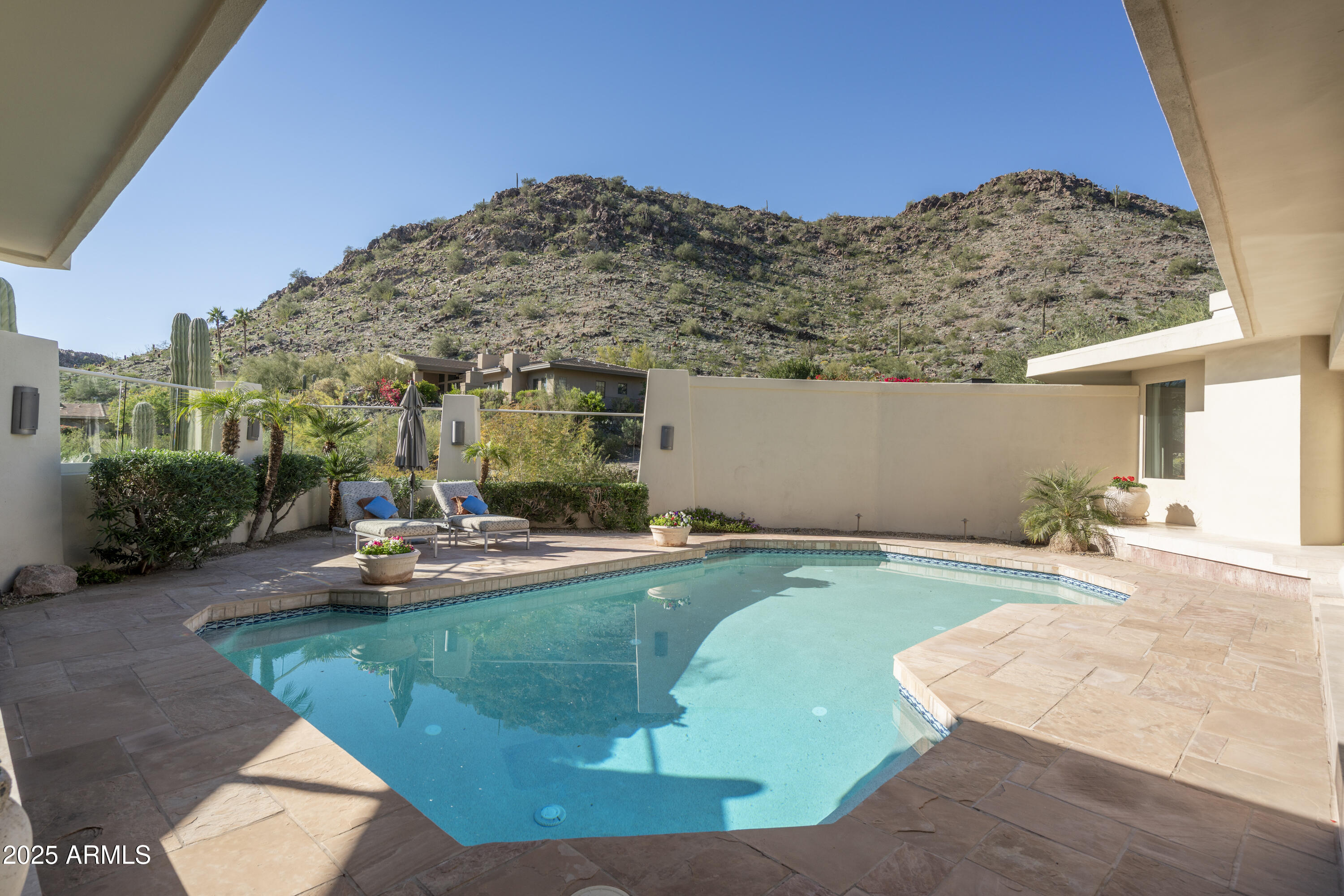 *Currently the only home in 85018 in a guard gated community with city lights AND mountain views UNDER $3 mil.   This exquisite estate in prestigious guard-gated community Lincoln Hills is
perched atop its own private peak.  Fabulous lock & leave home with TWO Primary suites.  Beautifully remodeled open-concept kitchen features walnut & creamy custom cabinetry paired with Sub Zero and Wolf appliances.   A well-appointed butler's pantry adds an extra layer of convenience, perfect for hosting and keeping the main kitchen tidy.   Primary suite features relaxing sitting area, double sinks, vanity counter, sauna for wellness, and built in refrigerator with bar area.   Fabulous outdoor living w/ built in BBQ area, covered patios with majestic mountain views, & glittering city lights at night! Lincoln Hills backs the Phx Mountain Preserve for access to hiking trails, community tennis court, pickleball, basketball court, grassy area for dogs, and community pool (in addition to your private pool). *FURNITURE AND DECOR ARE AVAILABLE TO PURCHASE on separate bill of sale.