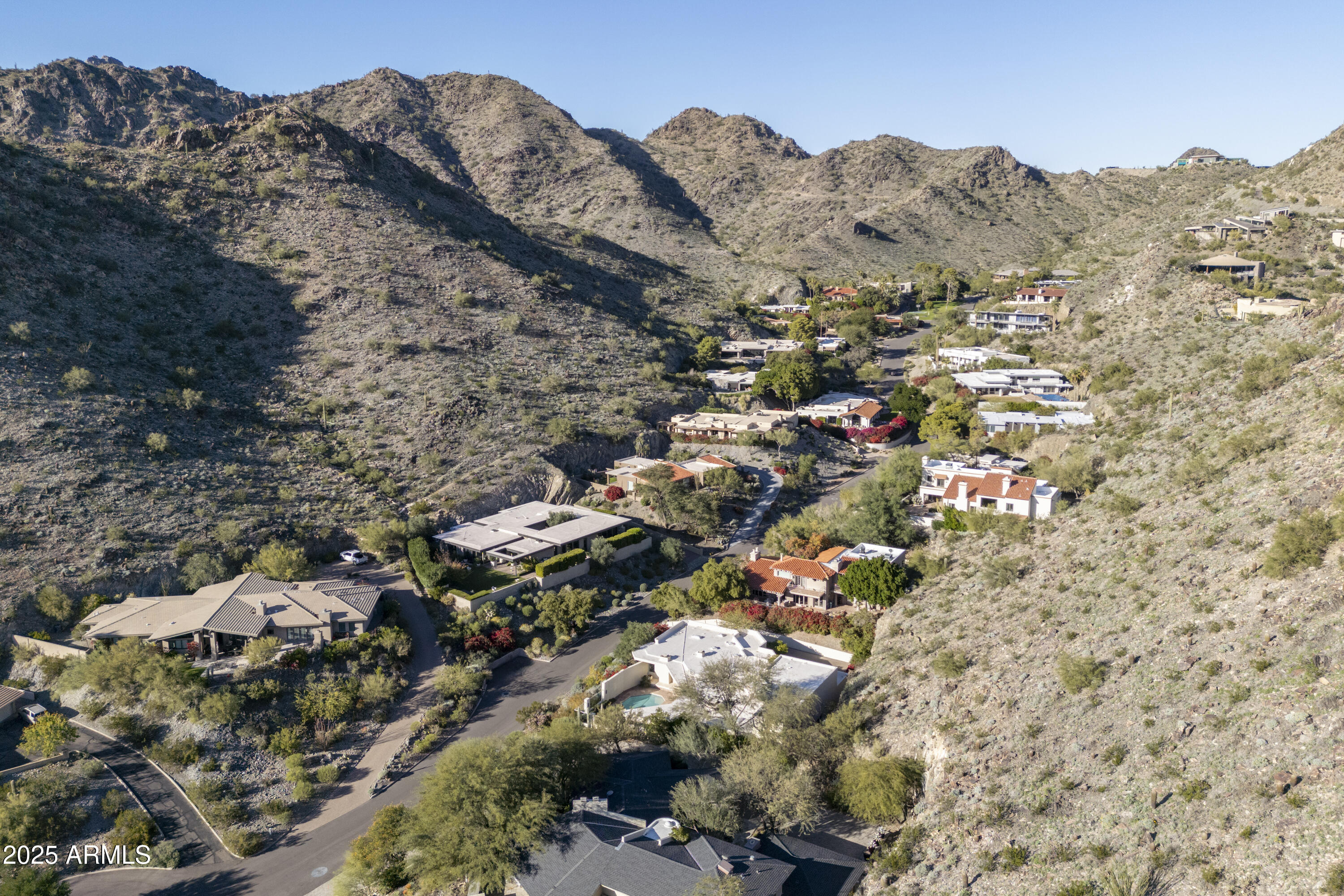 *Currently the only home in 85018 in a guard gated community with city lights AND mountain views UNDER $3 mil.   This exquisite estate in prestigious guard-gated community Lincoln Hills is
perched atop its own private peak.  Fabulous lock & leave home with TWO Primary suites.  Beautifully remodeled open-concept kitchen features walnut & creamy custom cabinetry paired with Sub Zero and Wolf appliances.   A well-appointed butler's pantry adds an extra layer of convenience, perfect for hosting and keeping the main kitchen tidy.   Primary suite features relaxing sitting area, double sinks, vanity counter, sauna for wellness, and built in refrigerator with bar area.   Fabulous outdoor living w/ built in BBQ area, covered patios with majestic mountain views, & glittering city lights at night! Lincoln Hills backs the Phx Mountain Preserve for access to hiking trails, community tennis court, pickleball, basketball court, grassy area for dogs, and community pool (in addition to your private pool). *FURNITURE AND DECOR ARE AVAILABLE TO PURCHASE on separate bill of sale.