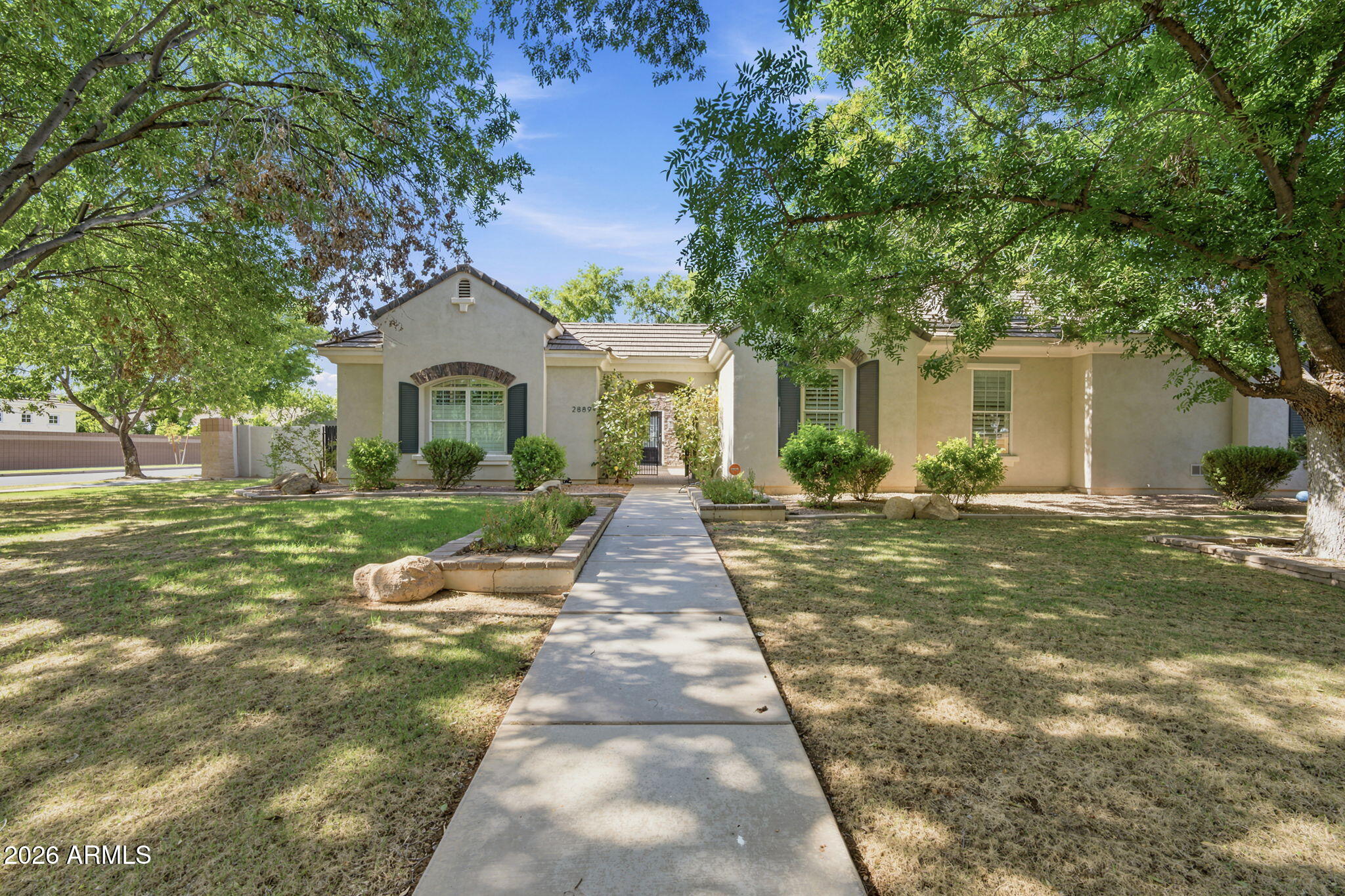 This beautiful single-story home is located in the highly desirable Morrison Ranch. It's a rare find, sitting on almost a 1/2 acre in a quiet cul-de-sac with tree-lined streets, and is one of the largest floorplans in Higley Groves West. With over 4,600 sq/ft of living space, 10' ceilings, and custom woodwork and cabinetry throughout, it has 5 bedrooms and 3.5 bathrooms in the main house, plus another bedroom and bathroom in the attached casita.

The kitchen is the central focus, with a large island, marble counters, Thermador appliances, dual dishwashers, a 6-burner gas range, dual gas ovens, a pot filler, microwave drawer, and a walk-in pantry with plenty of additional storage. Updated LED lighting and beautiful wood floors add to the home's move-in-ready feel. The home is also pre-wired for surround sound, including the game room and covered patio. Complete with its own walk-in closet, the game room offers the flexibility to serve as a 6th bedroom if needed. The attached casita has its own entrance, making it a great option for a home office or guest space. Most of the bedrooms have walk-in closets, giving you ample room for storage, and a dedicated laundry room offers a sink and counter space of its own. RO and whole-house water softener systems are already in place.

The backyard is shaded by large mature trees and also features an in-ground spa. With close proximity to the 60 and 202 freeways, shopping at San Tan Village, and only 25 minutes to the Phoenix Sky Harbor airport, this home truly has it all!