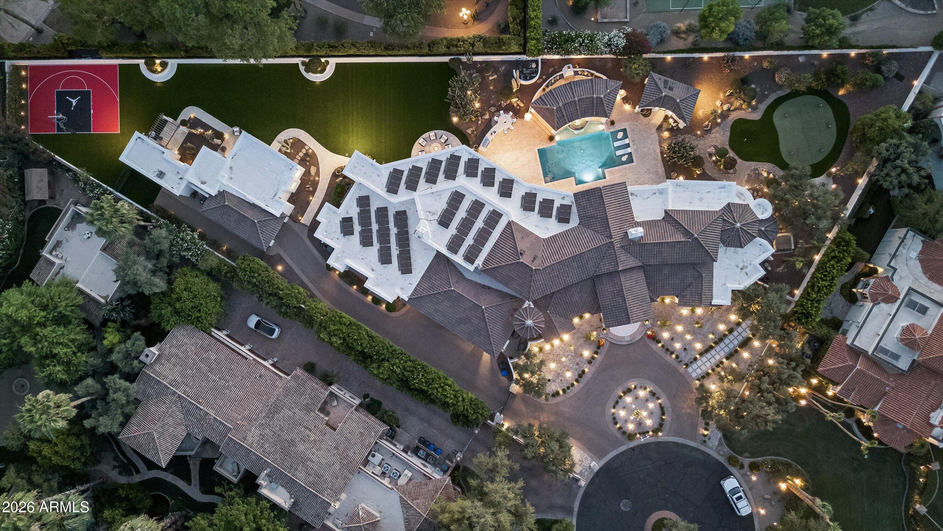 Rare & amazing opportunity within the 24/7 guard-gated Finisterre enclave, this extraordinary Paradise Valley estate offers 9,281 square feet of comprehensively reimagined luxury framed by iconic views of The Praying Monk, Camelback Mountain, and Mummy Mountain. Thoughtfully redesigned by emerging architect Yap-Chan of Arizona State University, the residence seamlessly blends refined modern design with timeless desert architecture, creating a private sanctuary defined by sophistication, wellness, and effortless indoor-outdoor living. Designed for grand-scale entertaining and intimate everyday living alike, the 7,586-square-foot main residence showcases expansive gathering spaces, soaring ceilings, museum-quality slab limestone, engineered white oak flooring, new energy-efficient windows and doors, integrated smart-home technology, whole-home water filtration, and an air-conditioned four-car garage. At the center of the home, an expanded chef's kitchen was curated for elevated entertaining, featuring dual islands, premium Miele and Viking appliances, and two walk-in pantries, all thoughtfully connected to elegant living and dining spaces. An inviting wine room offers a refined setting for collectors and intimate gatherings .Beyond the main residence, a detached guest house/casita provides luxurious accommodations for extended stays or multigenerational living. Resort-inspired grounds unfold as a private desert retreat, where sweeping mountain vistas frame expansive outdoor living spaces designed for both recreation and relaxation. A dedicated sport court, spa-inspired wellness retreat complete with steam room and private pool bath, and thoughtfully designed entertaining areas create an atmosphere reminiscent of a world-class resort. Offering exceptional privacy, architectural vision, breathtaking natural beauty, and seamless luxury living within one of Paradise Valley's most coveted guard-gated communities, this is a truly rare opportunity to own an extraordinary desert estate.