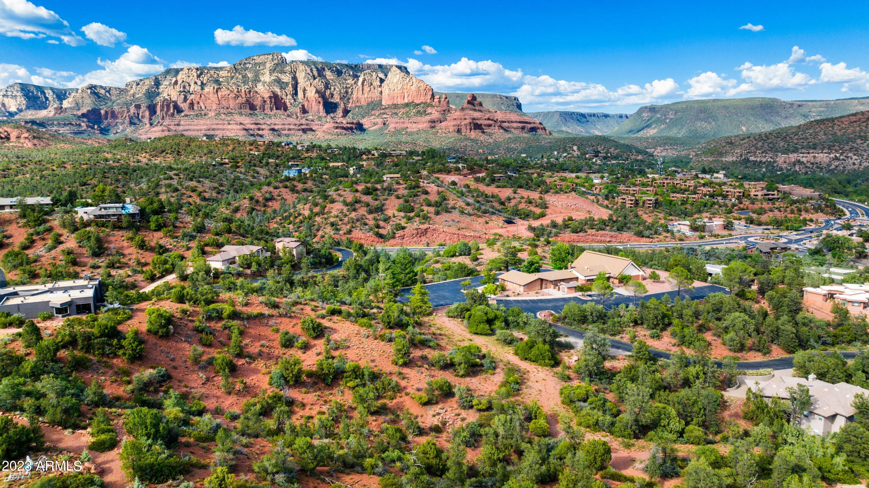 Sky Ridge Estates is Sedona's newest subdivision in the heart of Sedona. This lot is gently sloped to the northeast with fantastic panoramic red rock views over ponderosa pine and sycamore trees beside a wash. Very secluded with amazing views! Presently priced lower than sold comps for a limited time only until the road and all underground utilities are completed, scheduled for late-2026. Short walk to new town square, grass/park fields, city park and museums, Tlaquepaque, high-end shopping and dining, Los Abrigados Spa resort, restaurants, gym, lit tennis and pickleball courts, and Oak Creek front park available for membership. This is a residence club lot, meaning it is within a gated, secure subdivision with an adjoining clubhouse/CCRC continuing care retirement community, anti-aging medspa, and amenities, offering property management, room service, and 5-star management, with 24-hour security (not Airbnb). Very quiet and secluded, yet in the heart of Sedona, with a 10 walkability score.

Below-Market Pricing: Secure your slice of paradise with lots starting at just $549,000. Only 7 lots remaining 
Build Your Dream: Choose our innovative, eco-friendly landscape homes featuring rustic contemporary design, metal accents, and ceiling-to-floor glass, crafted for efficiency and elegance. 

Unparalleled Views, Privacy, very quiet & secluded:

19 Exclusive Lots: Each lot, ranging from half to three-quarters of an acre, offers breathtaking panoramic views along a serene ridge down and through a hidden canyon.

Investment & Lifestyle Flexibility: Residence club
Luxury Living Redefined: Sky Ridge Estates isn't just a place to live; it's a lifestyle. This 5-star resort community offers:
*Private Club & Fine Dining (room service): Experience culinary delights without leaving the comfort of your community.
*Wellness & Leisure: State-of-the-art anti-aging spa, fully-equipped gym, yoga studio, indoor climate-controlled pickleball court, and a golf simulator.
*Concierge & Transport: Enjoy the convenience of concierge services, a Mercedes limo van for all your travel needs, and 24-hour security guard and cameras.
*Resort-Style Property Management: Travel a lot? 2nd Home? On-site property management is available.

*Infrastructure is underway, and roads and utilities are being installed. The clubhouse and gate are pending approval.

Collaborate with our top architect and builder to bring your vision to life. Contact us for more details on this unique opportunity.

Look under photos and website for home renderings and drone footage of each lot. Don't miss out on this chance to invest in a lifestyle of luxury and tranquility at Sky Ridge Estates.
*Clubhouse is not part of the subdivision but adjoins it and gates are pending plan approval.
Most recently sold lot comp lots in residence clubs);
1.)60 Indian head lane .54 acre lot 1/15/2024 sold for 1,250,000.
2.)170 HIDDEN MEADOW DR 7, 1.3-acre lot 3/26/2025 sold for 3,100,000
3.)75 PASEO DEL INEZ 7; 81-acre lot 1/13/2026 sold for 1,350,000.