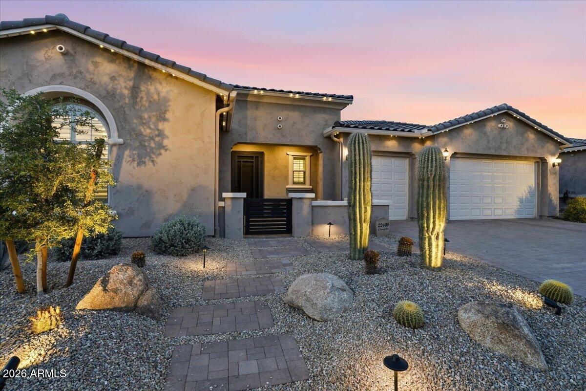 Situated on one of the most desirable lots in Harvest, this extensively upgraded Pulte Virtue offers exceptional privacy with a premium corner lot location, only one neighboring home, greenbelt views, and a surrounding streetscape of single level homes. Built in 2024 and enhanced far beyond builder standards, this 3 bedroom plus office, 2.5 bath residence combines luxury, functionality, and thoughtful design throughout.

Inside, luxury vinyl plank flooring, plantation shutters, motorized shades, integrated audio, and whole home smart technology create a refined living experience. The expansive great room centers around a beautifully appointed chef's kitchen featuring leathered granite countertops, double stacked cabinetry extending to the ceiling, KitchenAid appliances, double ovens.cont a gas cooktop, oversized island, and walk in pantry. A spacious office with French doors and private patio access offers flexibility for work, hobbies, or additional living space.

The primary suite serves as a private retreat with dual vanities, a freestanding soaking tub, oversized walk in shower with rain head and bench seating, and a generous walk in closet. Additional upgrades include a whole home water filtration system, water softener, reverse osmosis system, tankless water heater, EV charging outlet, and epoxy finished 3 car garage.

Designed for Arizona living, the backyard showcases extensive travertine hardscaping, artificial turf, integrated patio audio, landscape lighting, sunset views, and gas and electrical connections already in place for a future outdoor kitchen or entertainment space. Permanent exterior lighting, mature saguaro landscaping, and a full French drain system further highlight the attention to detail and investment throughout the property.

Located within the gated section of Harvest, residents enjoy access to community amenities while being just minutes from Queen Creek's most popular destinations, including Schnepf Farms, The Olive Mill, Horseshoe Park & Equestrian Centre, and the rapidly growing Pecan Lake Entertainment District. This is a rare opportunity to own a thoughtfully curated home where the upgrades, privacy, and lifestyle have already been completed for you.
