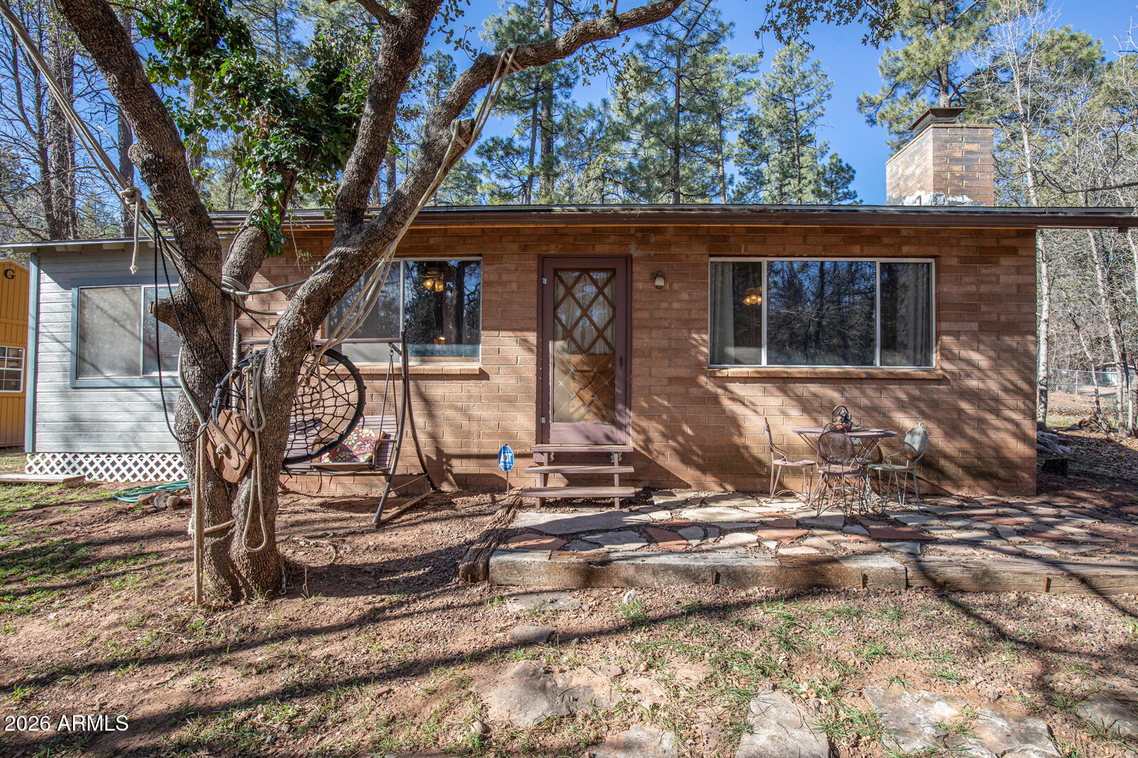 New listing price has been reduced to make this cabin affordable for a buyer to give it some updating and refreshing yard-grooming. Solidly built on a generous .32 acre lot, with beautiful trees for privacy. Inviting slate fireplace brings a warm ambiance, while you enjoy Deer and Elk wandering through this part of the forest. Two bedrooms plus bonus room, being sold 'As-Is' with plenty of room to expand or add a garage. Time to relax... restore... enjoy!