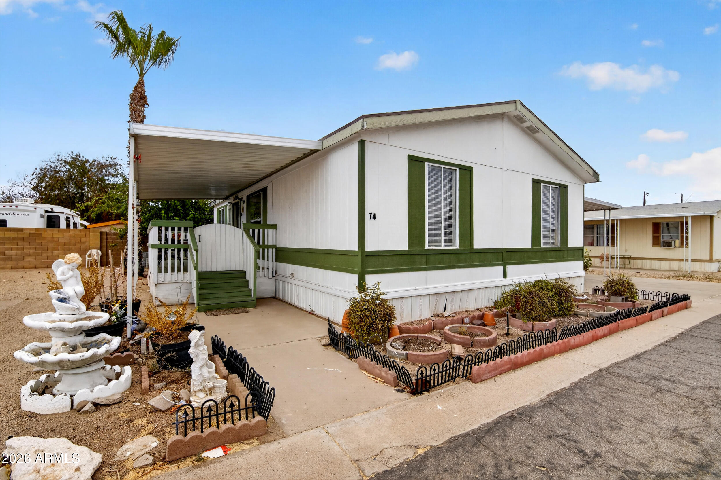 Welcome to McCoy Mobile Home Park -- a welcoming all-ages community. This light-filled 3-bedroom, 2-bath home offers an open floor plan with vaulted ceilings and a bright living area. The functional kitchen features ample cabinetry and gas cooking. Durable laminate and wood-style floors flow throughout, and the full bath includes a tiled vanity. Enjoy outdoor living on the expansive covered front deck--ideal for morning coffee or evening relaxation. Additional highlights include a double carport, built-in storage shed, and low-maintenance desert landscaping. Conveniently located near shopping, dining, and freeway access, this home blends comfort and convenience